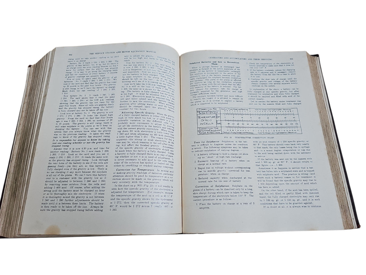 Open vintage manual book with dense text paragraphs on both pages