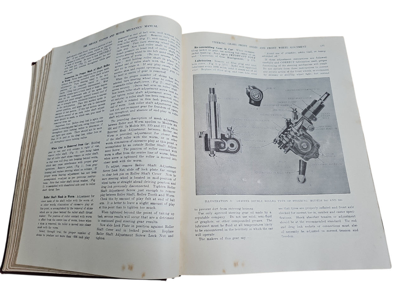 Open vintage manual book with dense text and labeled mechanical diagrams