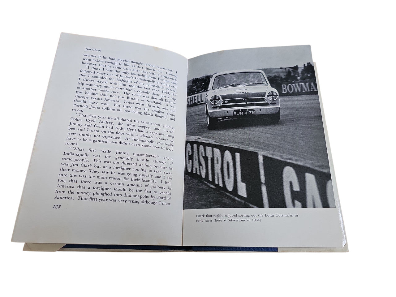 Opened motorsport book with racing photo and paragraph text on two pages