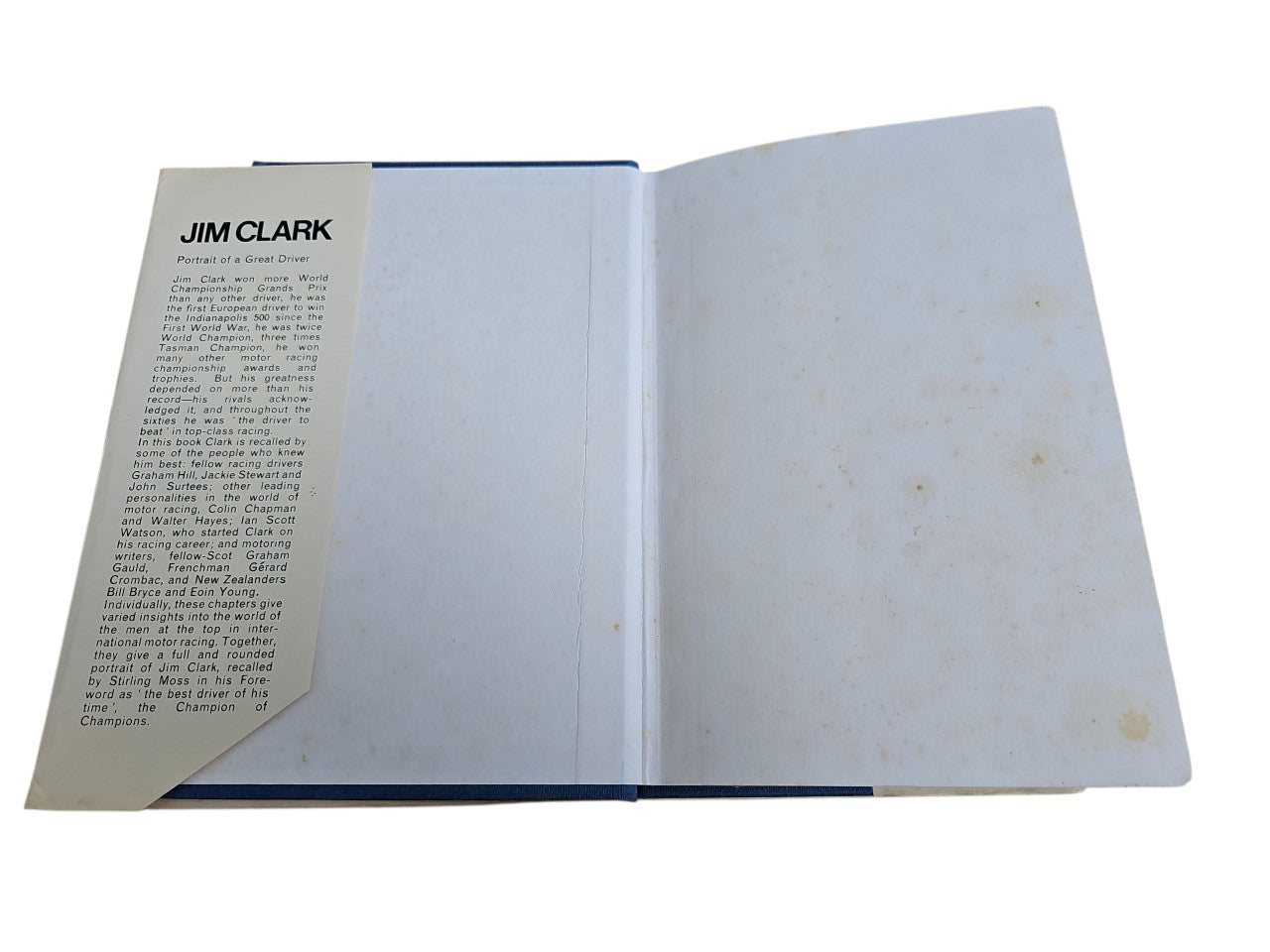Opened motorsport book with text page on the left and mostly blank right page