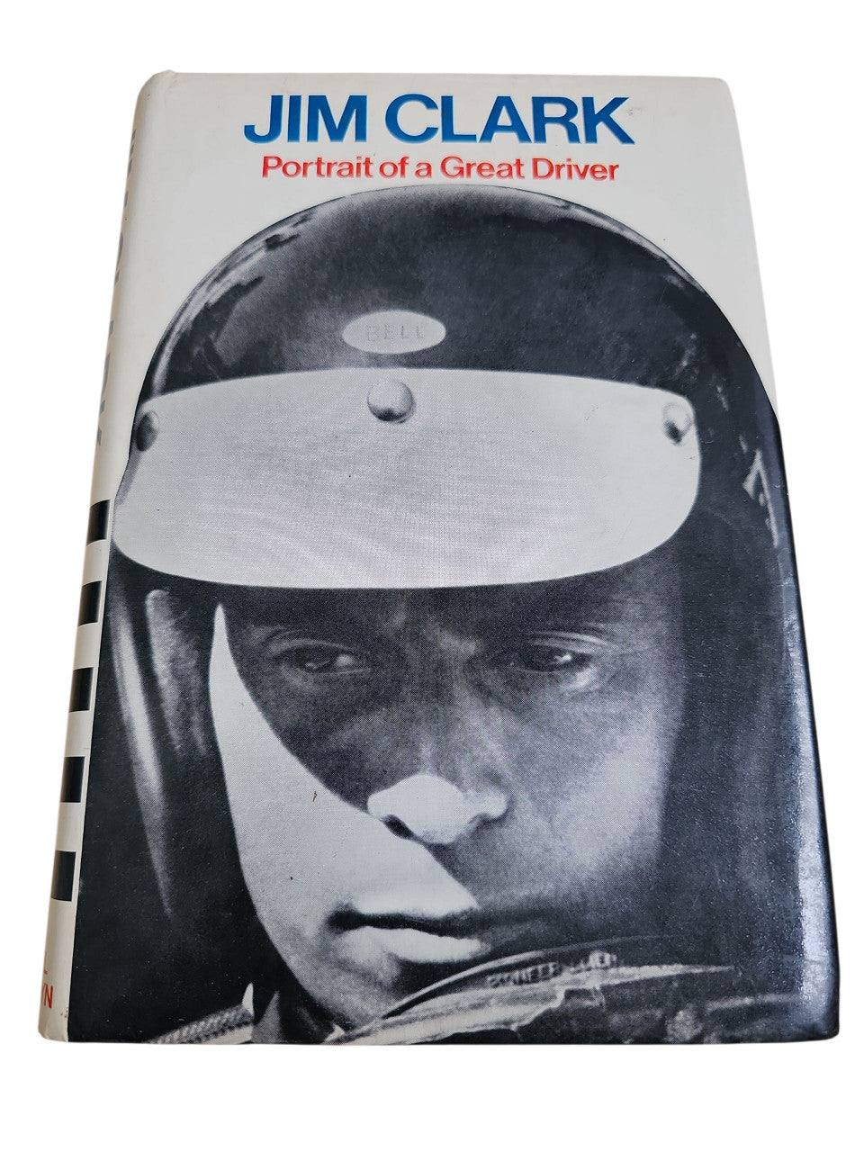 Paperback motorsport book cover with close-up black-and-white driver portrait and title