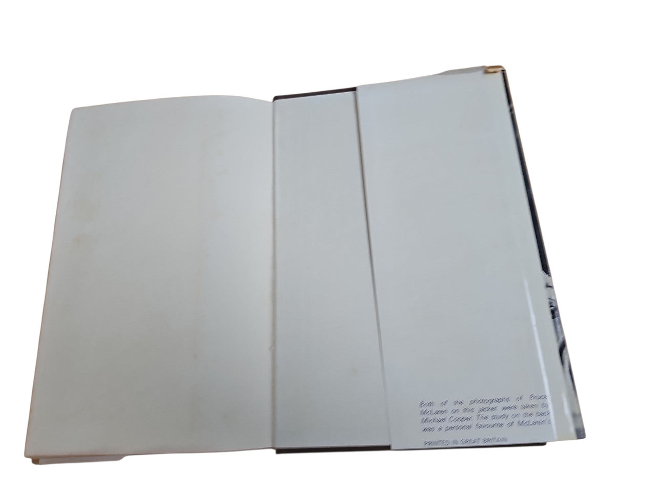 Open hardcover book with light pages, visible page text near bottom right