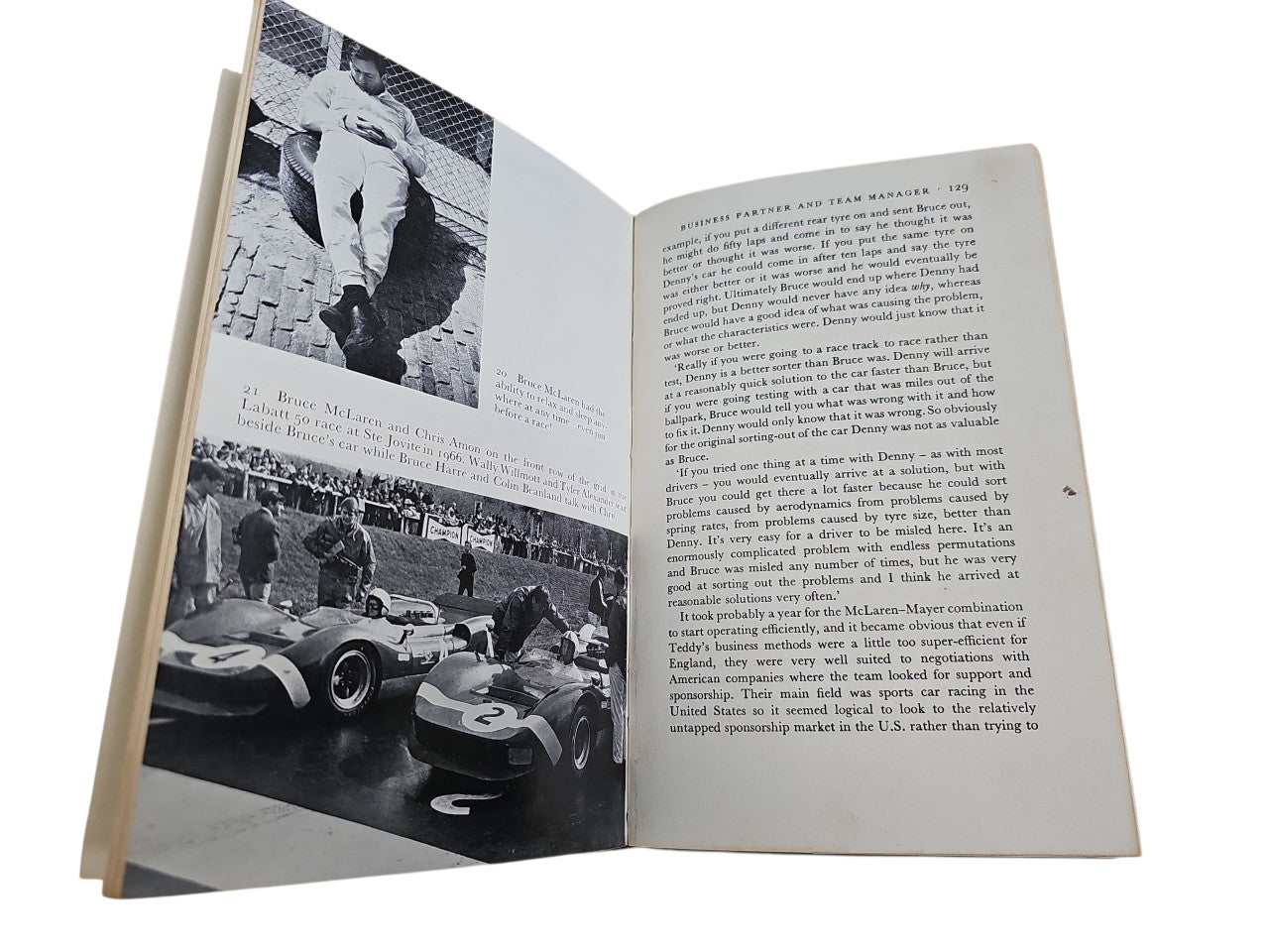 Book open with black-and-white racing photos and paragraph text on both pages