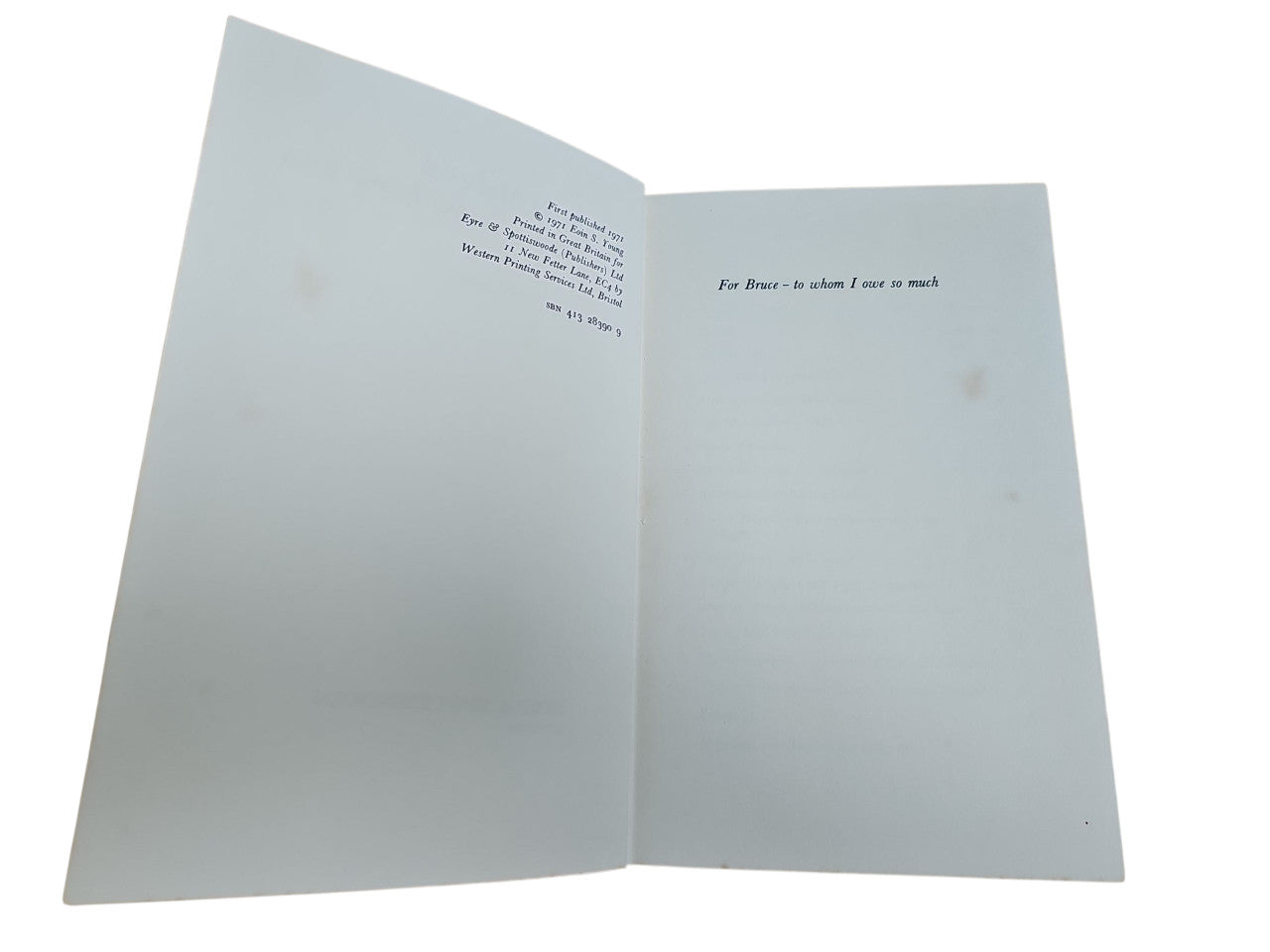 Book open flat showing blank pages with small printed text near the top