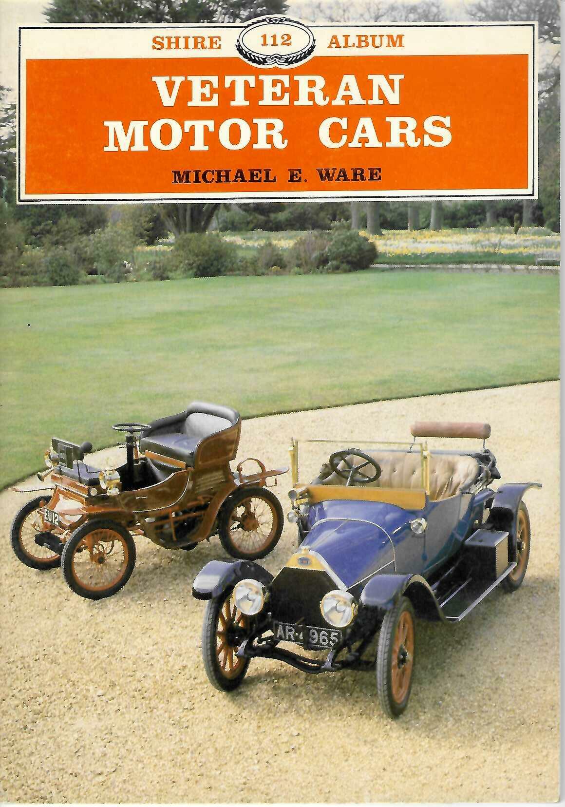 Hardcover book with orange cover, two vintage cars, and printed title text