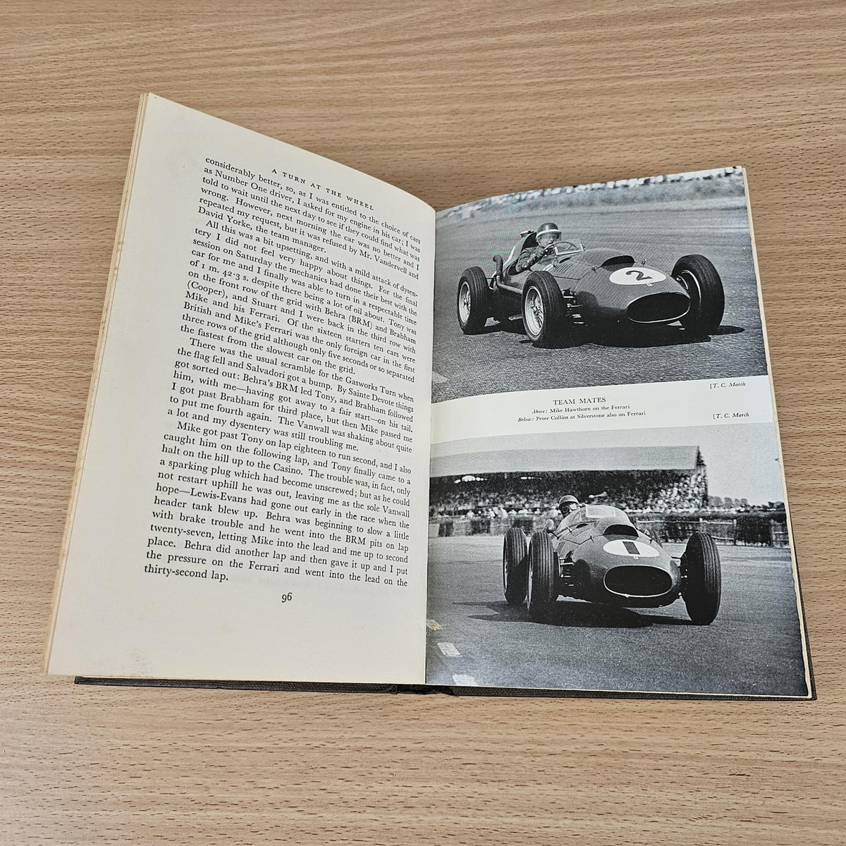 Open vintage racing book with text and two black-and-white car photos