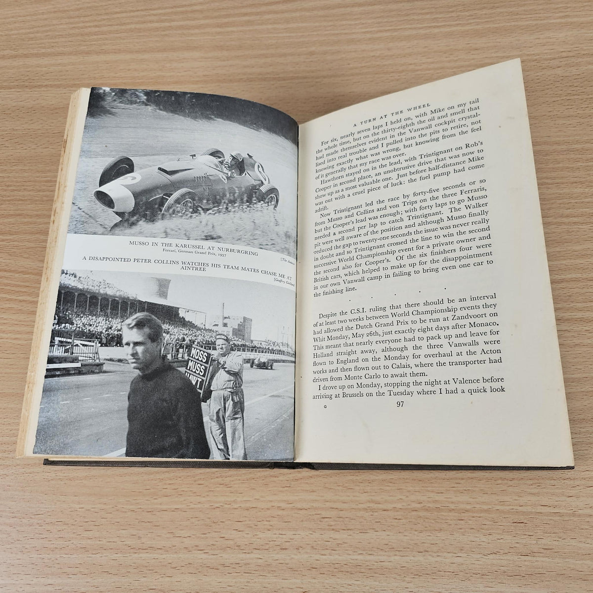 Open vintage racing book featuring black-and-white car and driver photos