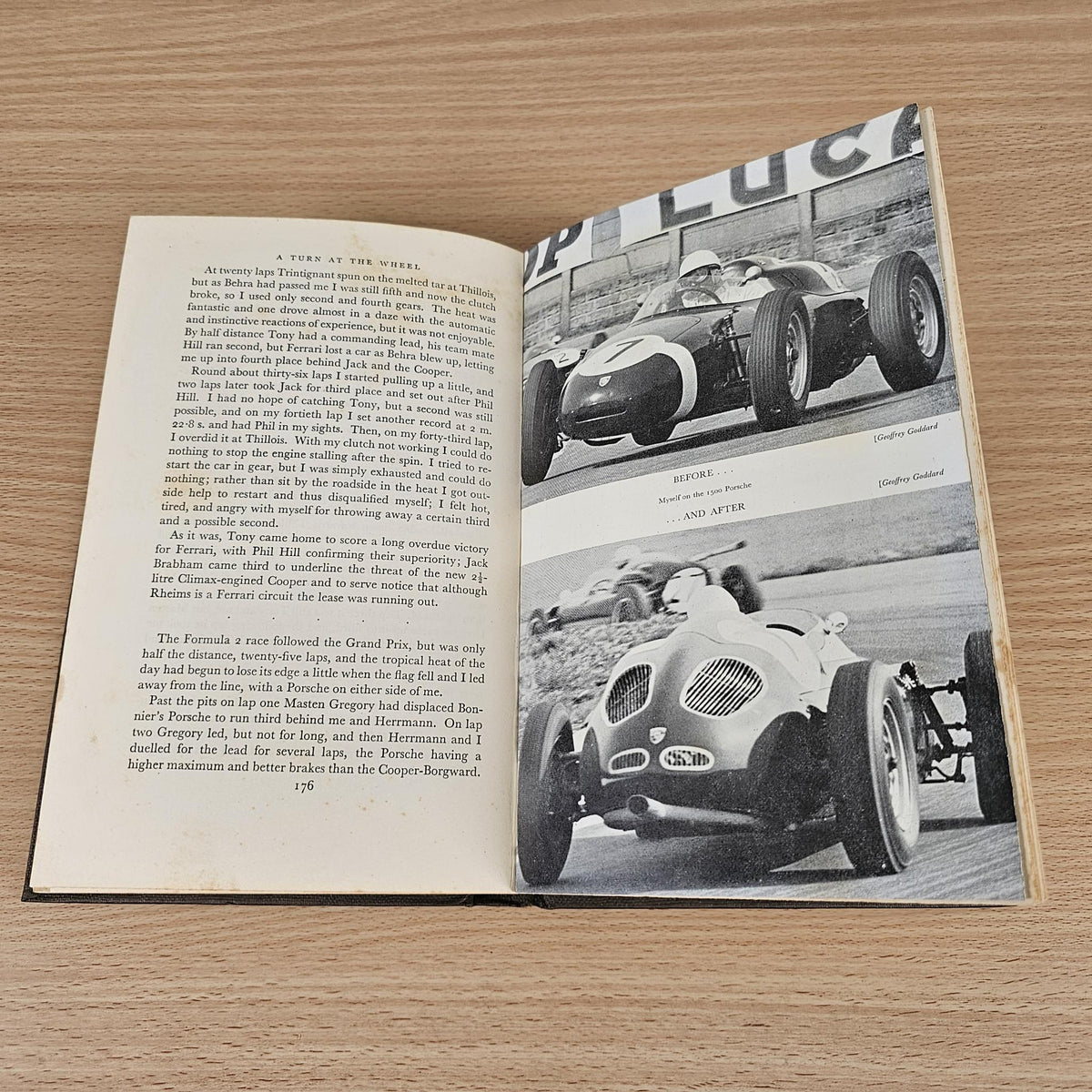 Open vintage racing book with text and two black-and-white car photos