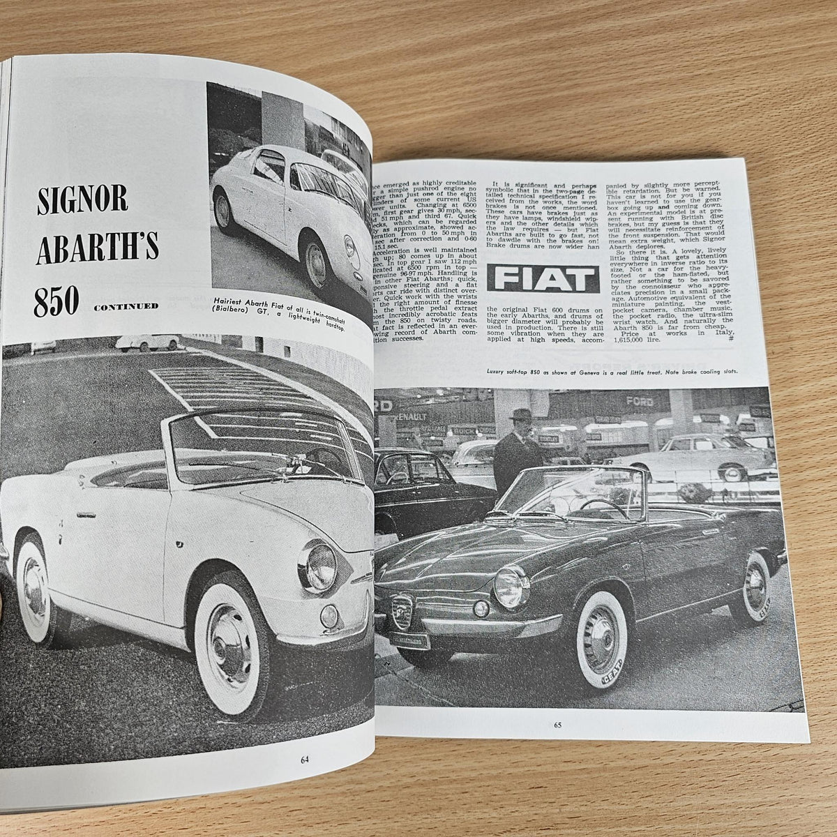 Paperback book with open pages of black-and-white classic car photos