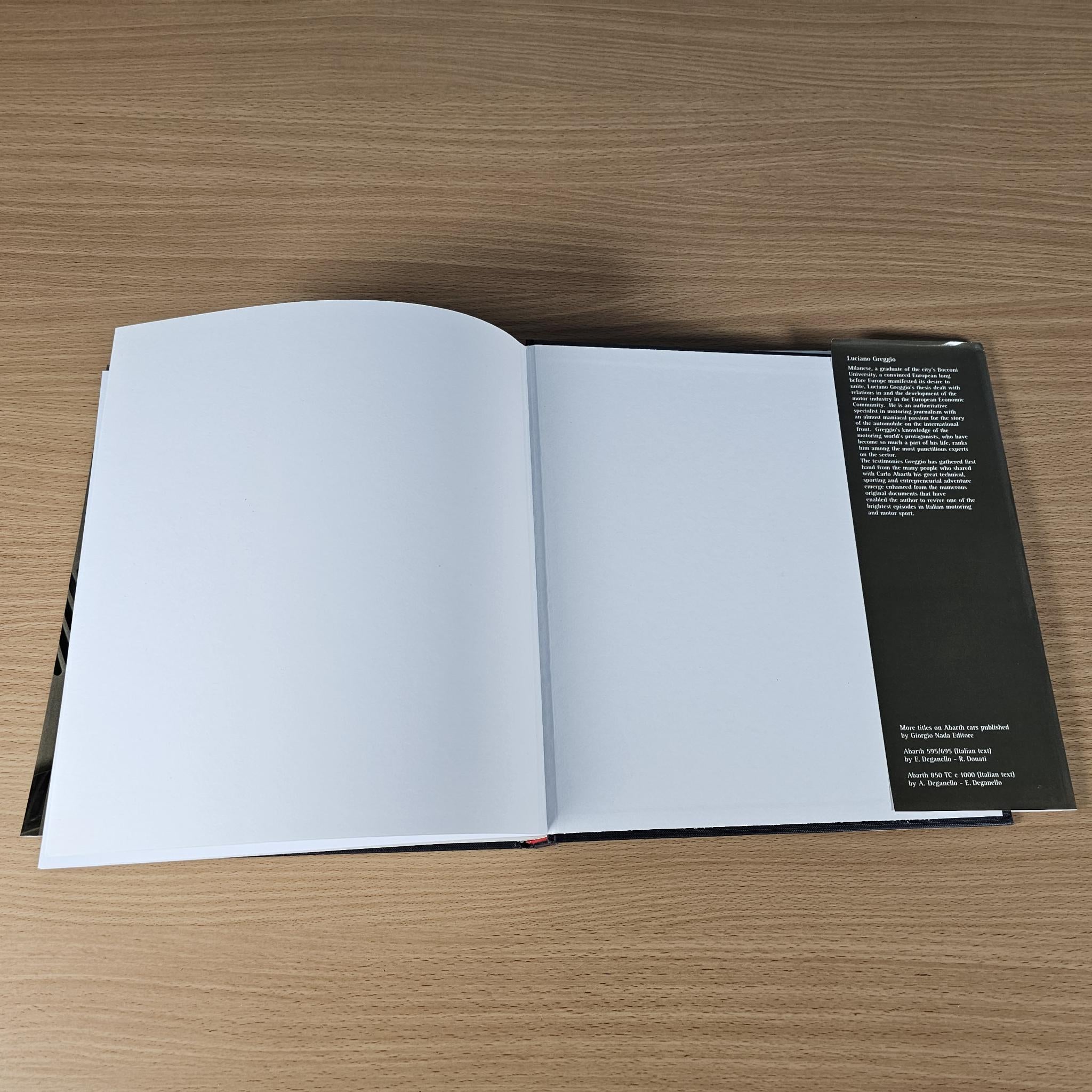 Open hardcover book with blank white pages and a dark information panel on the right