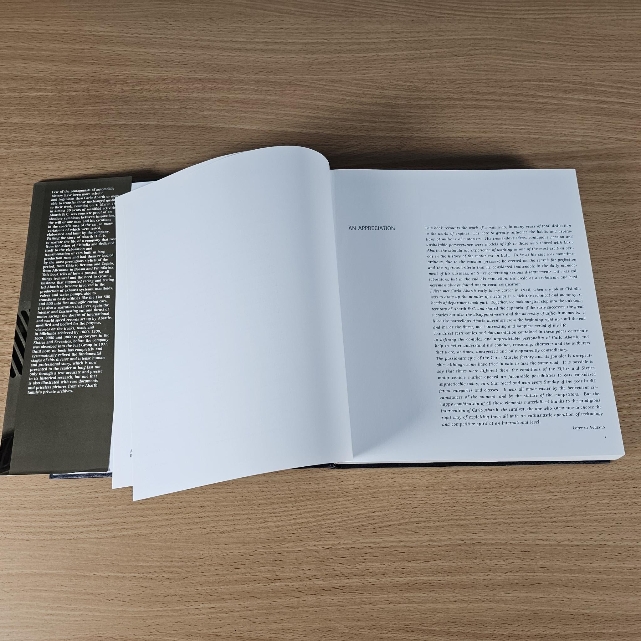 Open hardcover car book with two white pages filled with printed text.