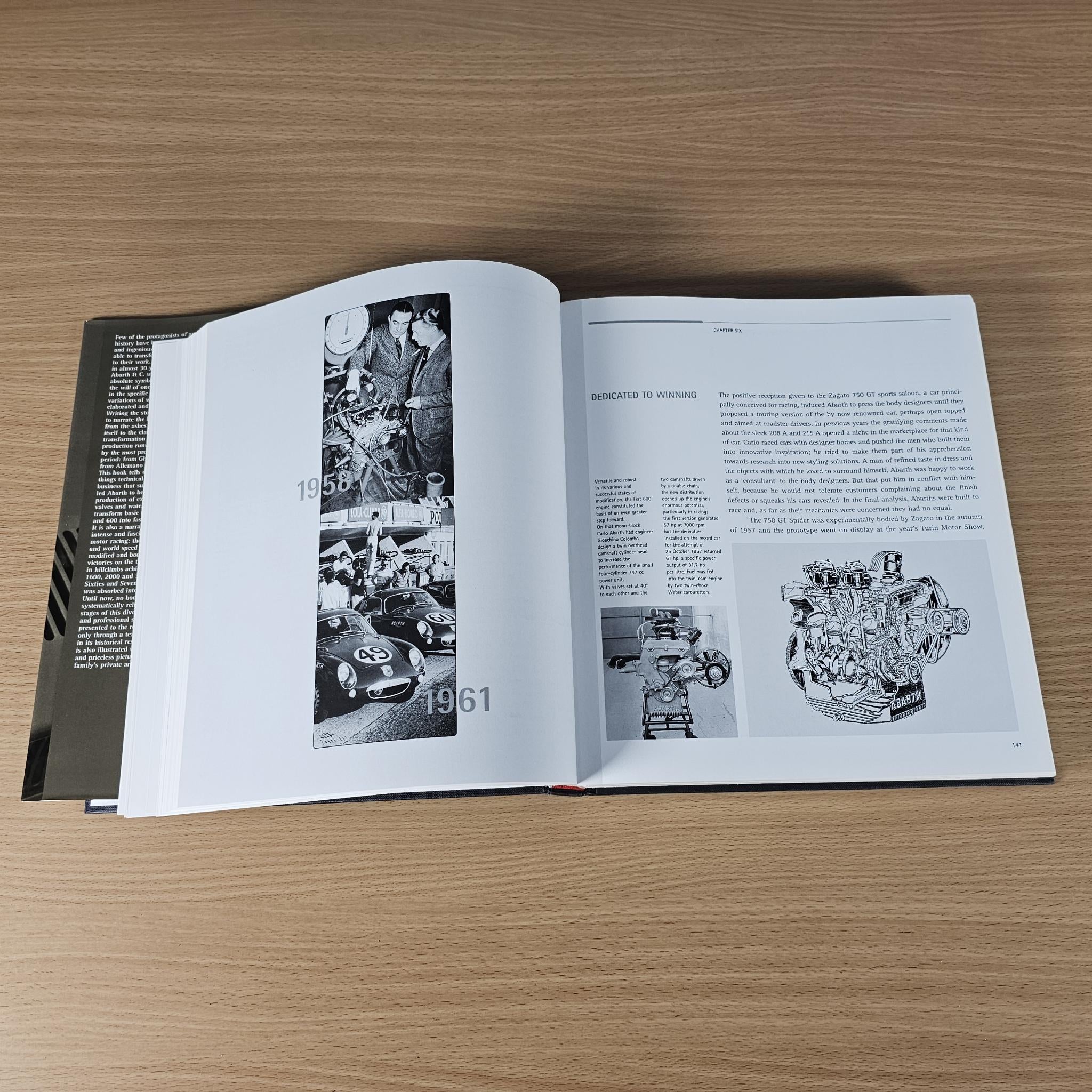 Open hardcover car book spread with vintage racing photos and diagrams.