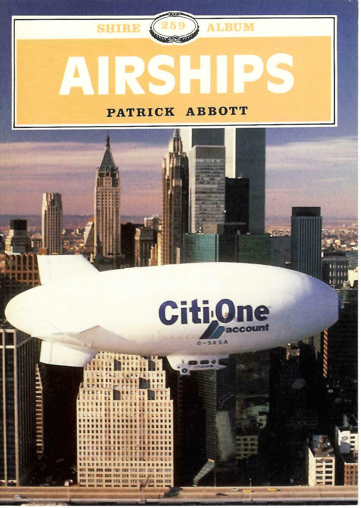 Paperback book with yellow 'Airships' cover, city skyline, and white airship