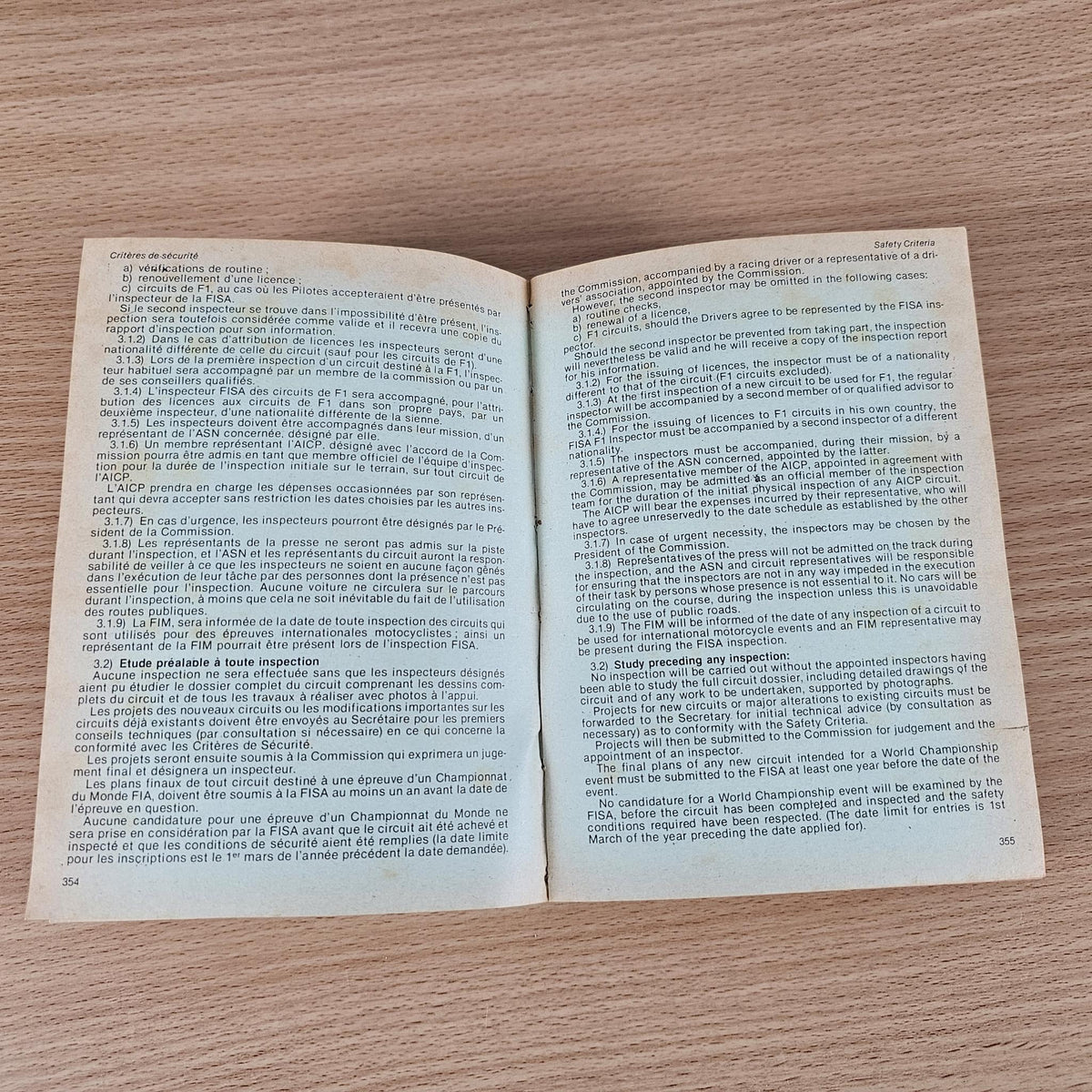 Open FIA year book pages with printed text paragraphs on both sides.