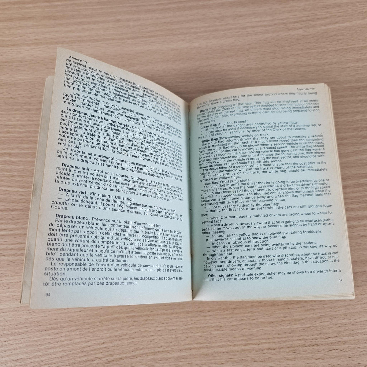 Open FIA year book spread with dense printed text across both pages.