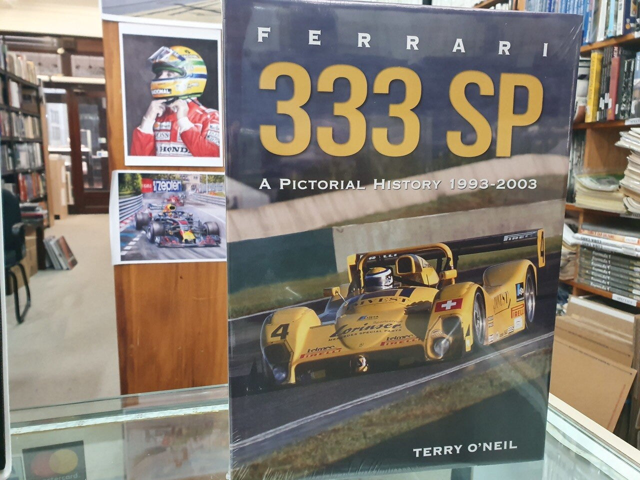 Ferrari 333 SP history book with yellow car photo and '333 SP' title