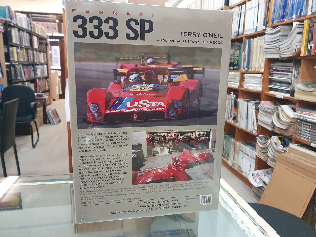 Ferrari 333 SP history book page with red race car image and small caption text