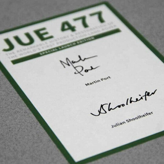 Signed vehicle history book with green title JUE 477 and handwritten signatures on cover