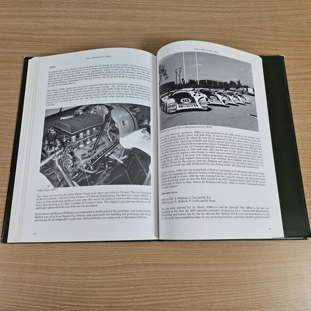 Hardcover racing book open with close-up engine photo on left page