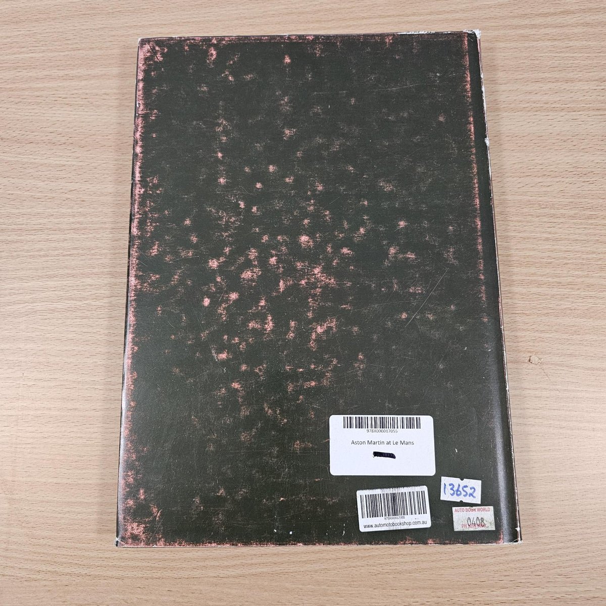 Hardcover book back cover, dark textured design with white barcode label