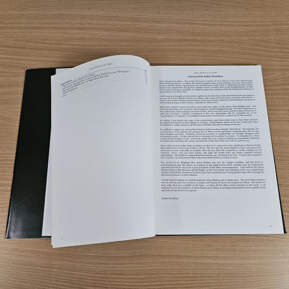 Hardcover book open showing printed paragraphs on two white pages