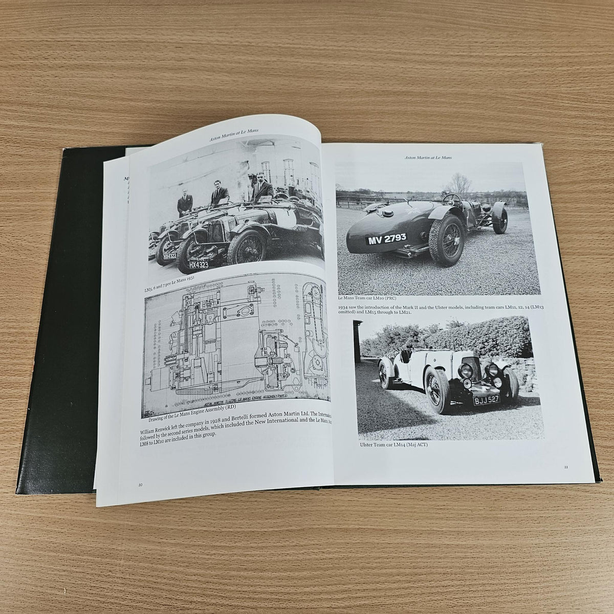Hardcover book open to vintage race photos and diagrams on two pages