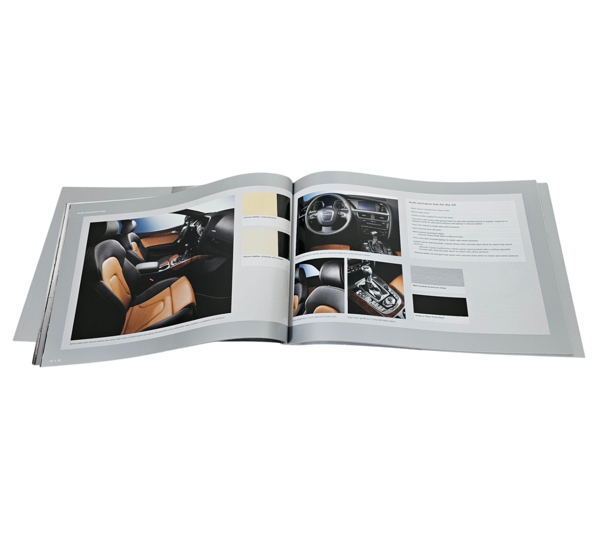 Audi A5 prestige portfolio booklet, open to interior cabin and dashboard photos