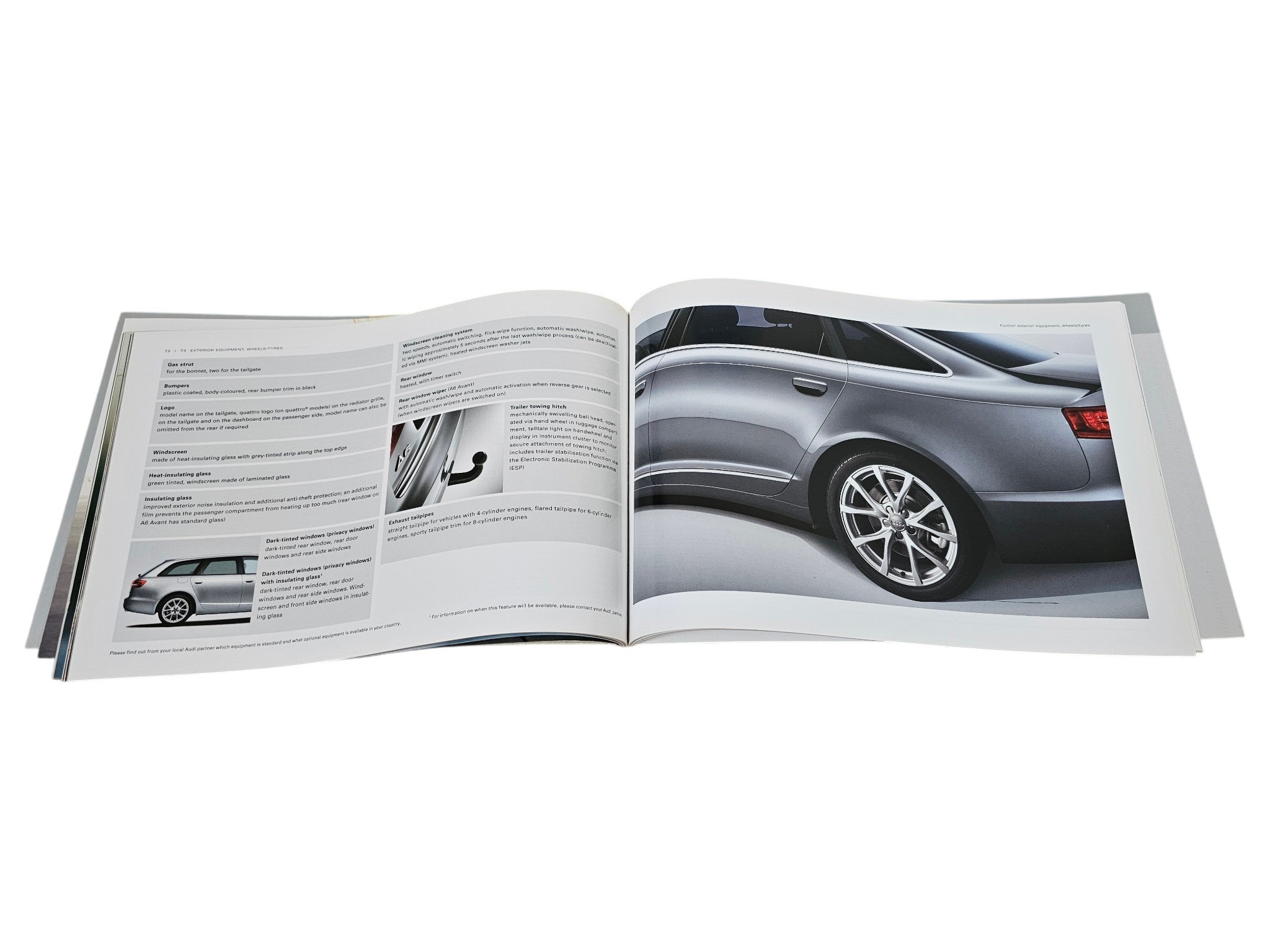 Opened brochure spread with diagrams and a gray car side exterior photo