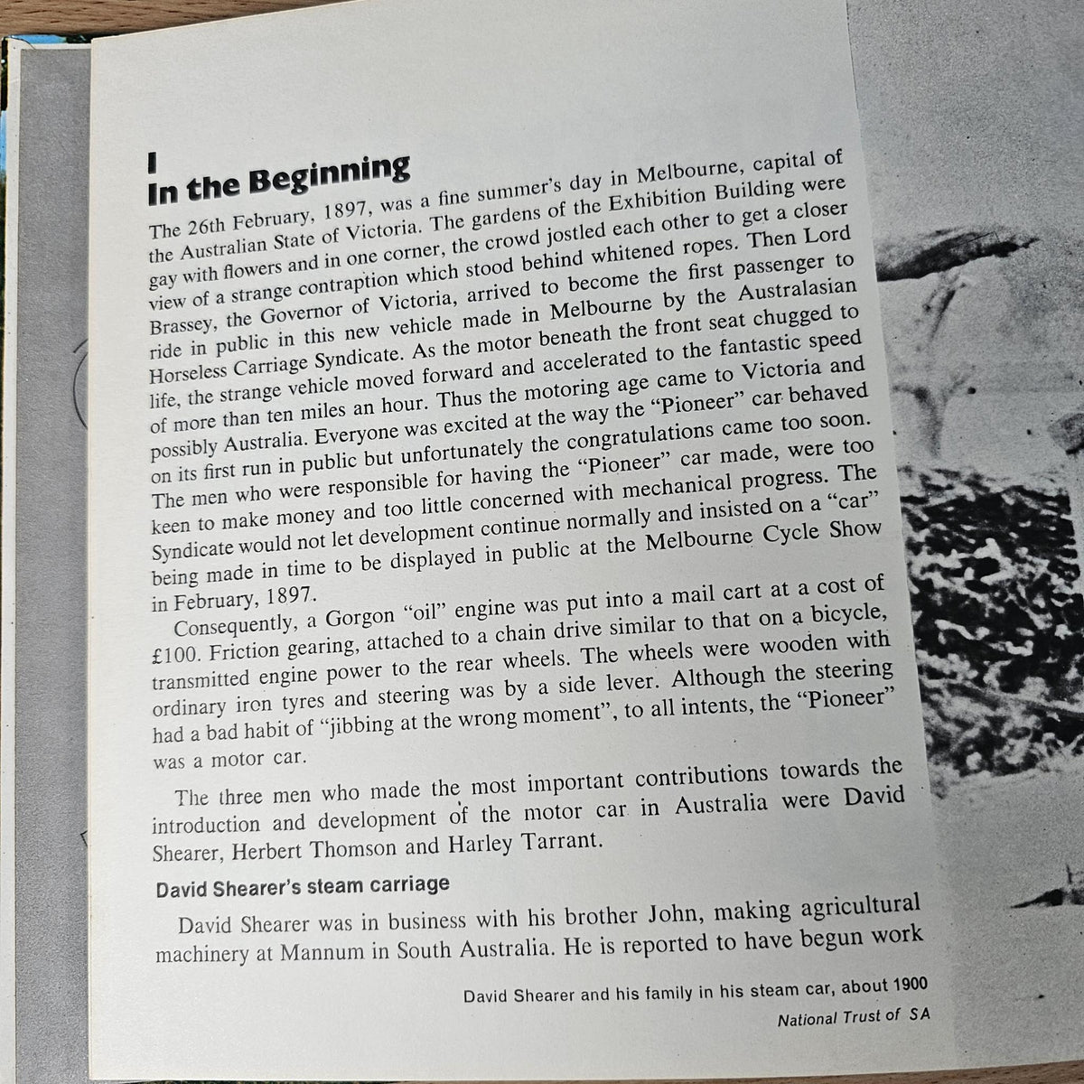 Hardcover automotive history book, close view of printed page text with title “In the Beginning”.