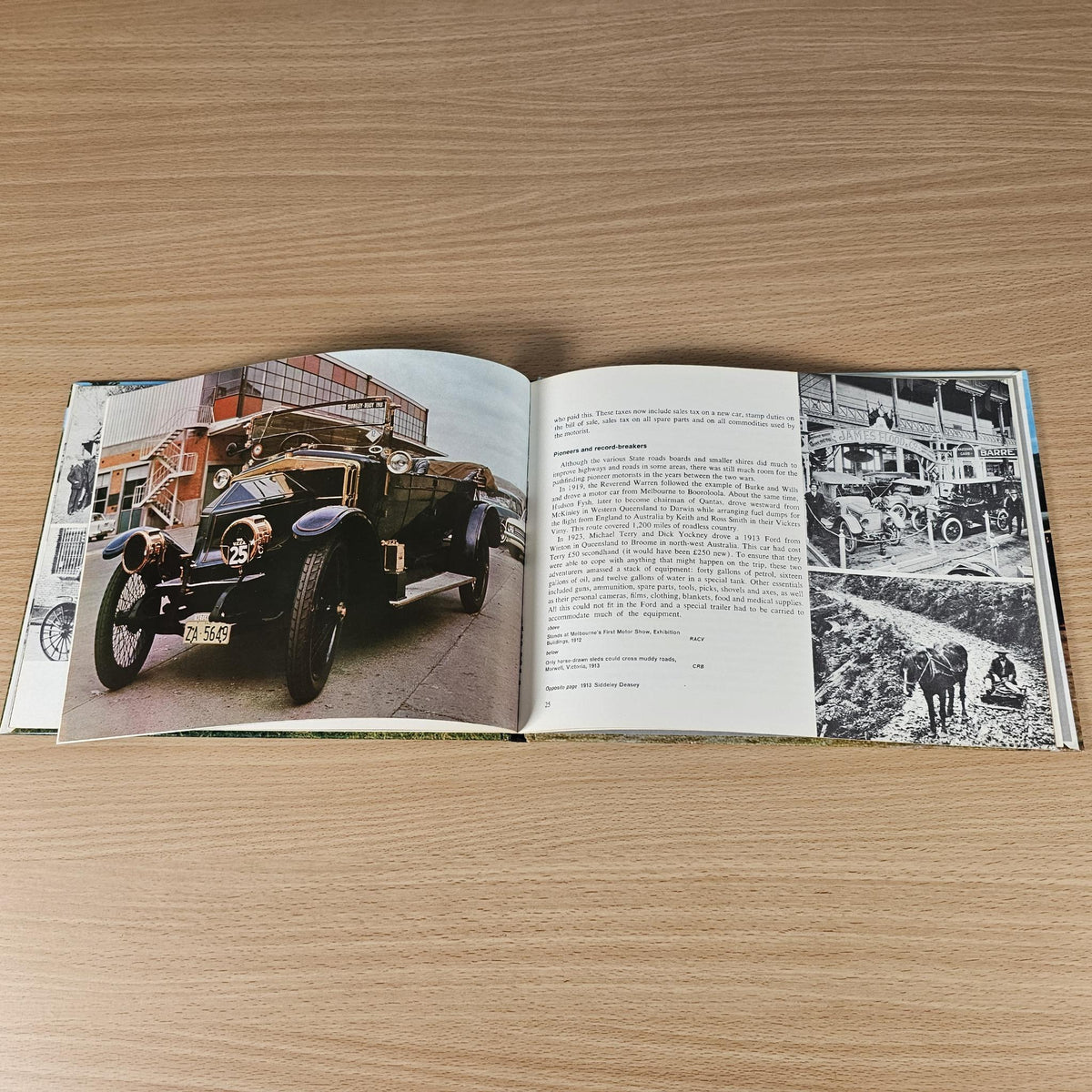 Hardcover automotive history book, open spread with vintage car image and printed text.