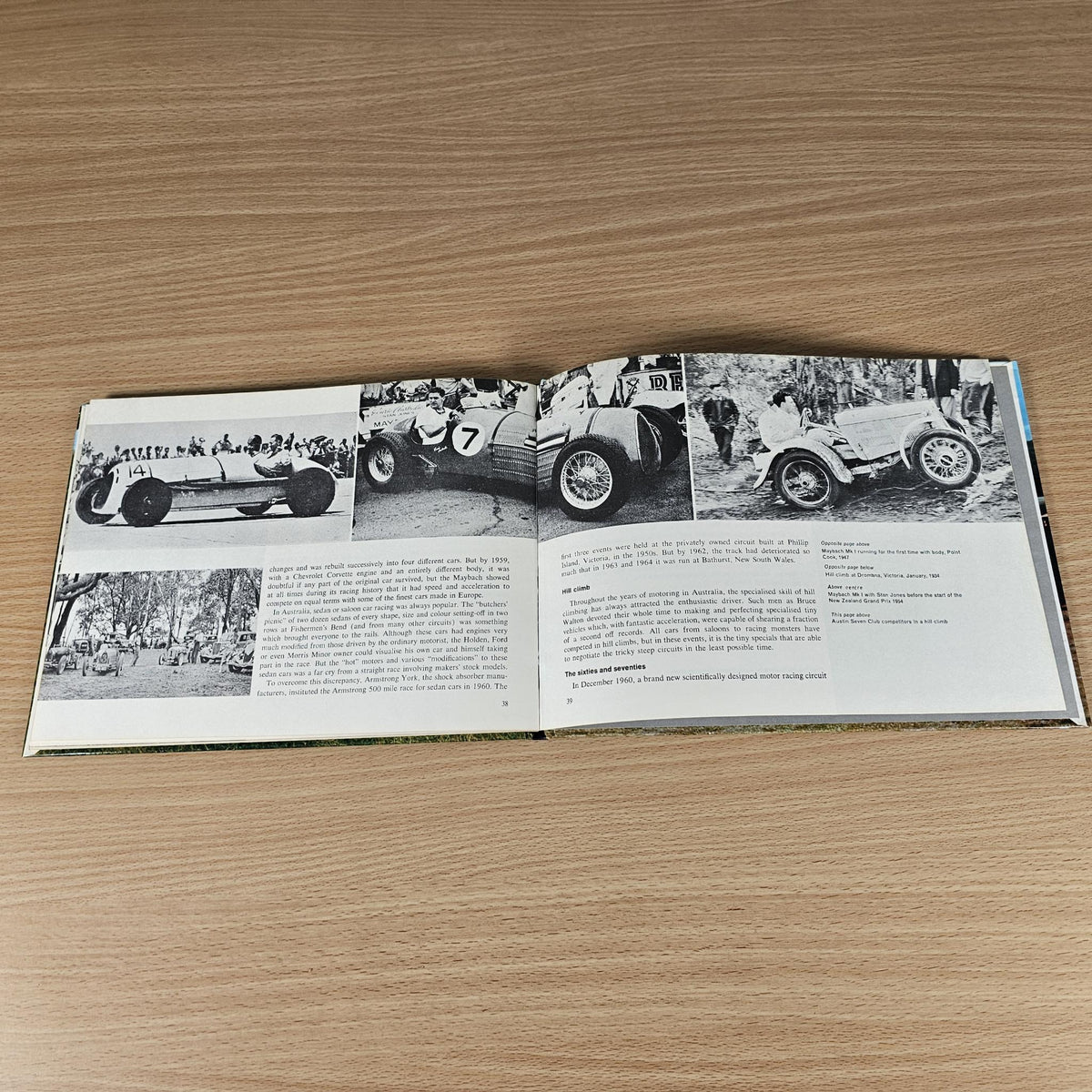 Hardcover automotive history book, open spread with multiple black-and-white car photos.