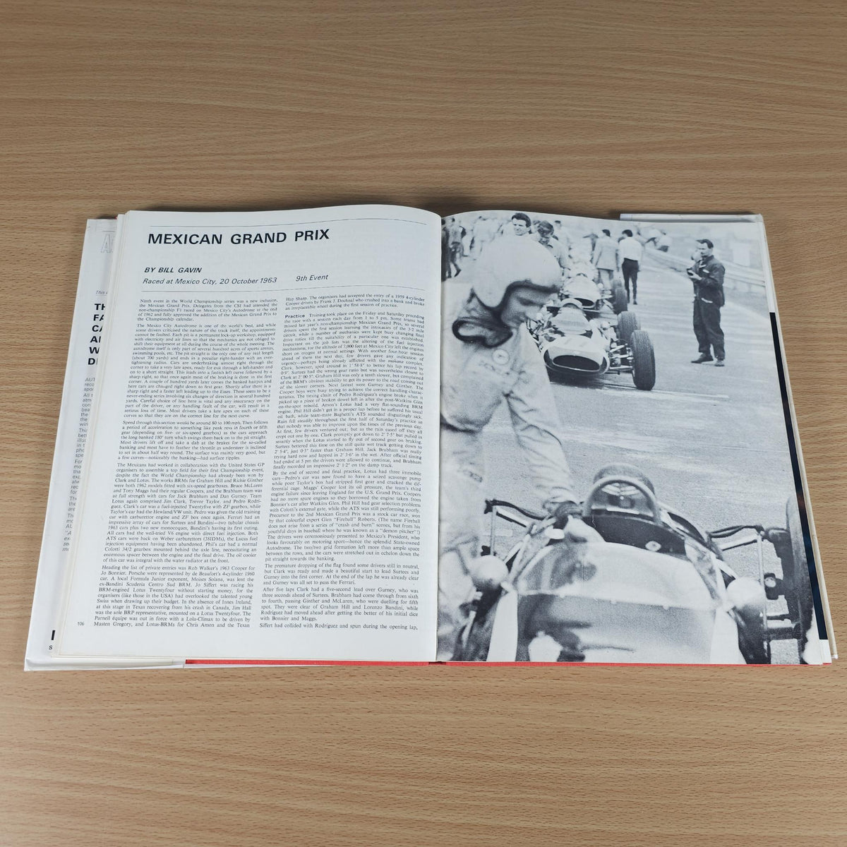 Open vintage motorsport review book with text and black-and-white racing photo spread