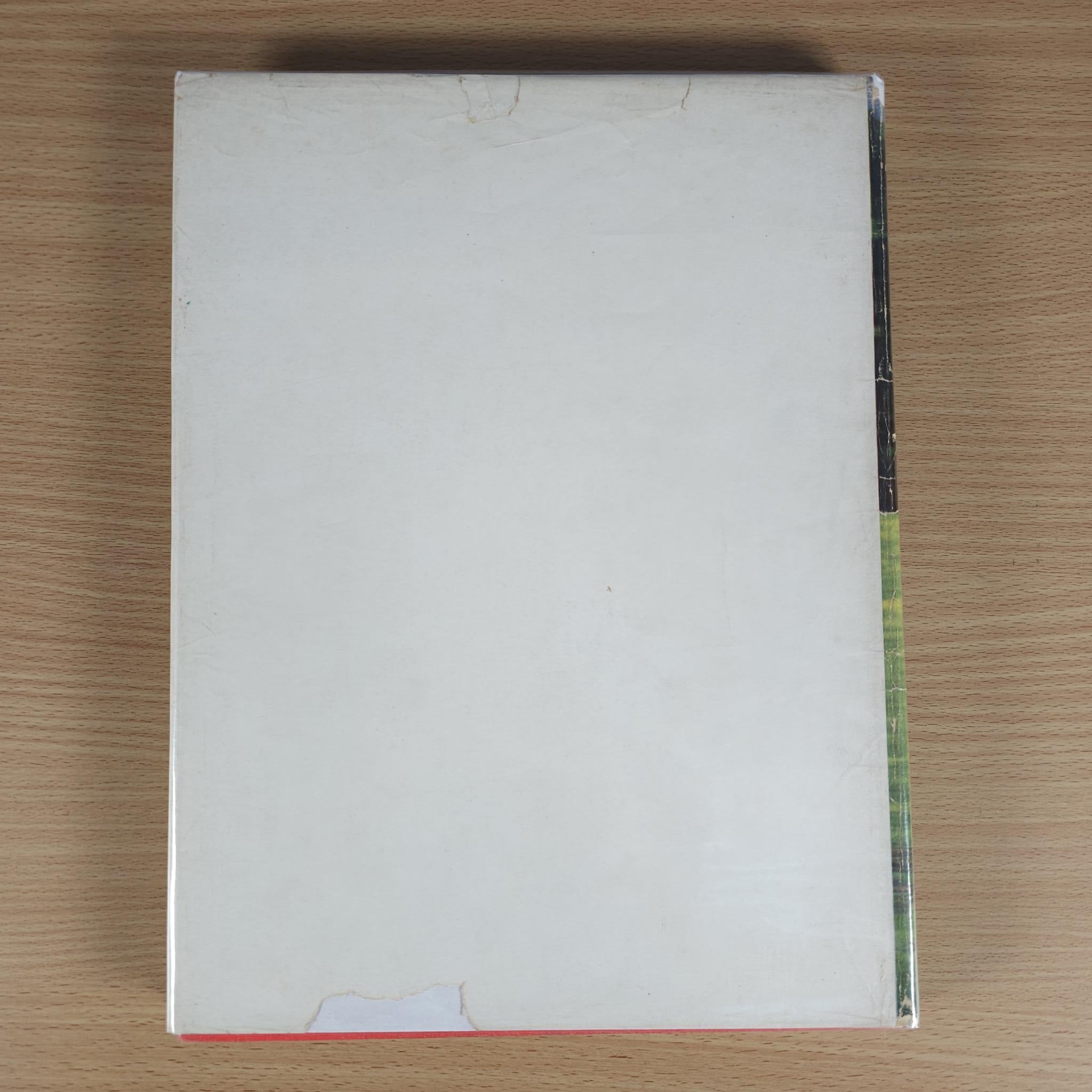 Vintage motorsport book back cover, mostly blank white with minor wear.