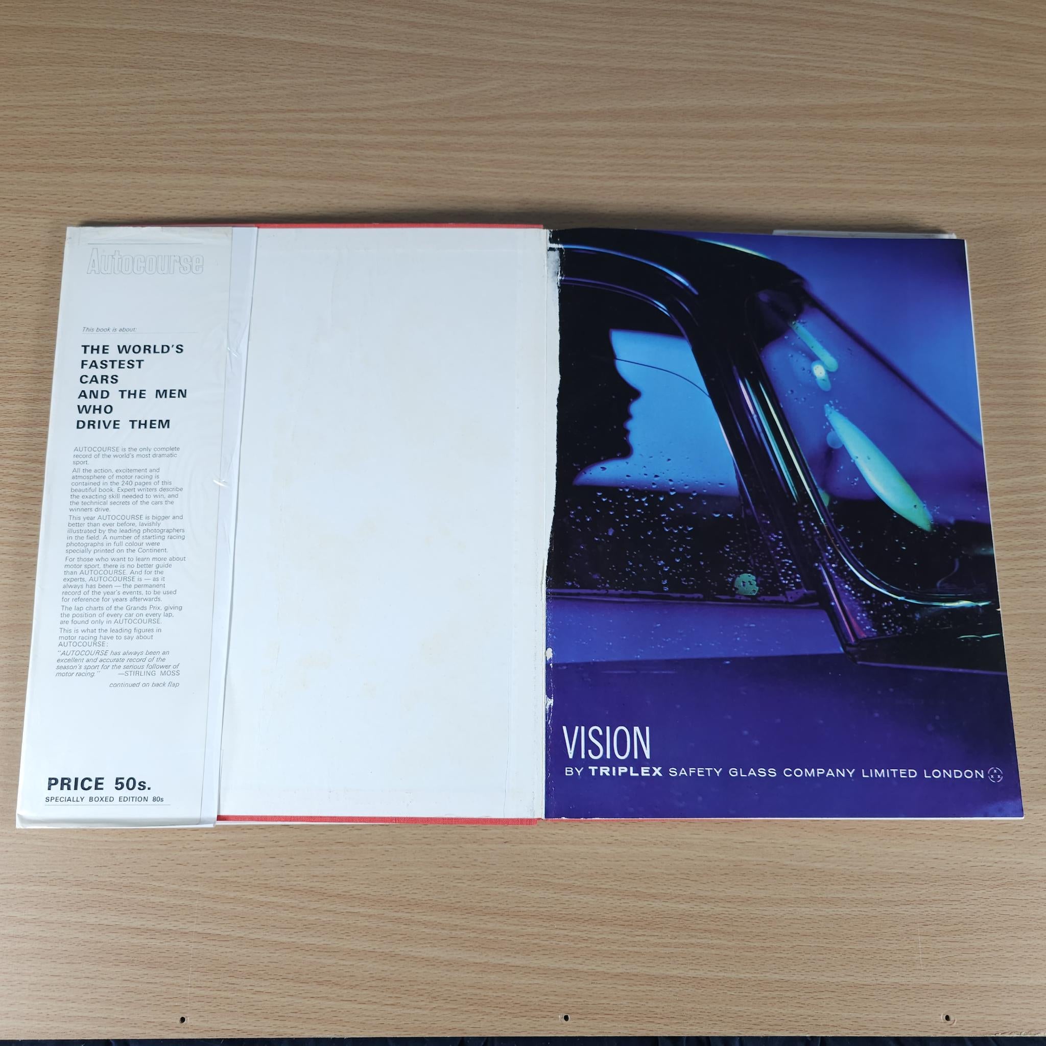 Opened motorsport book with left text page and right blue “VISION” page.