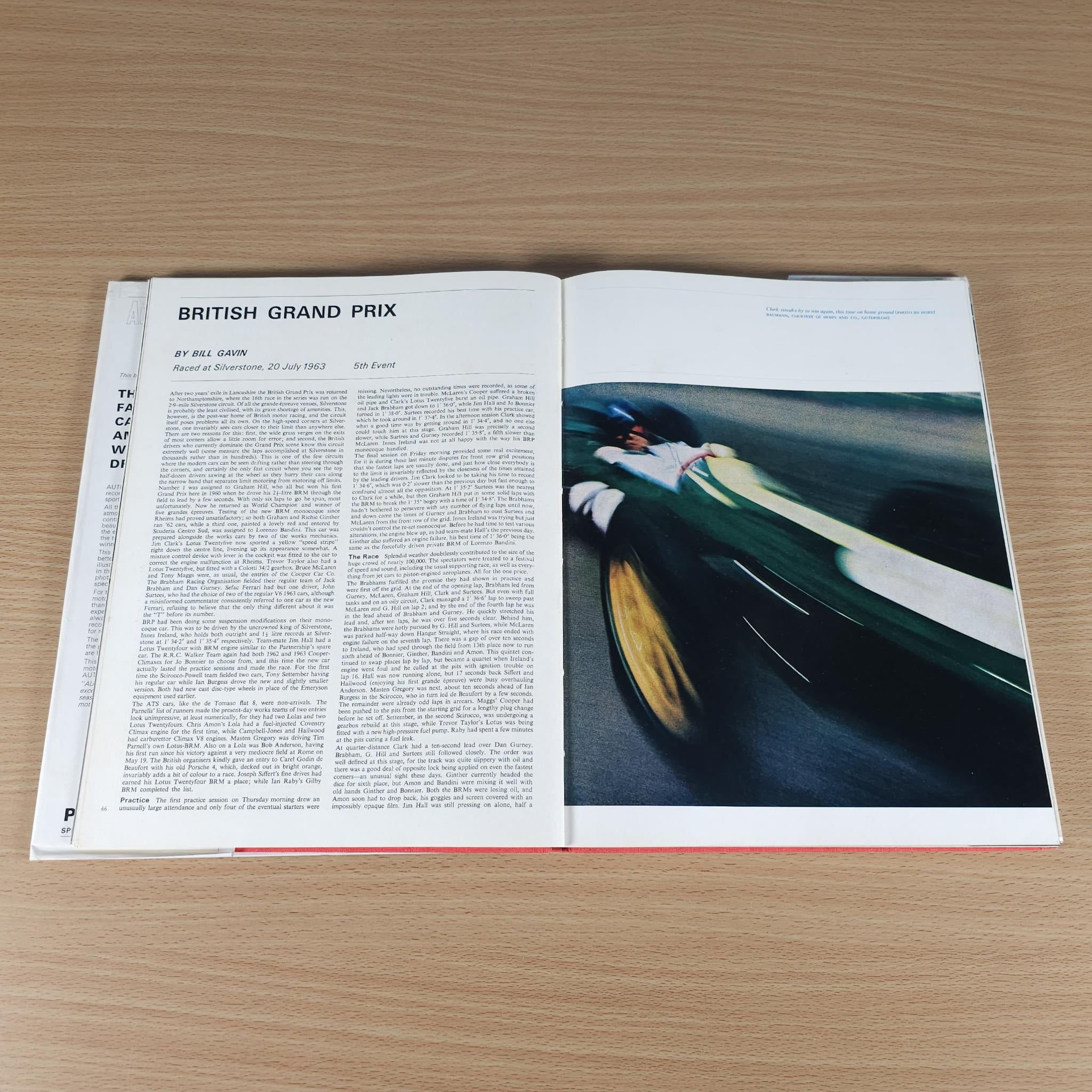 Opened motorsport book with “BRITISH GRAND PRIX” article and green race car photo.