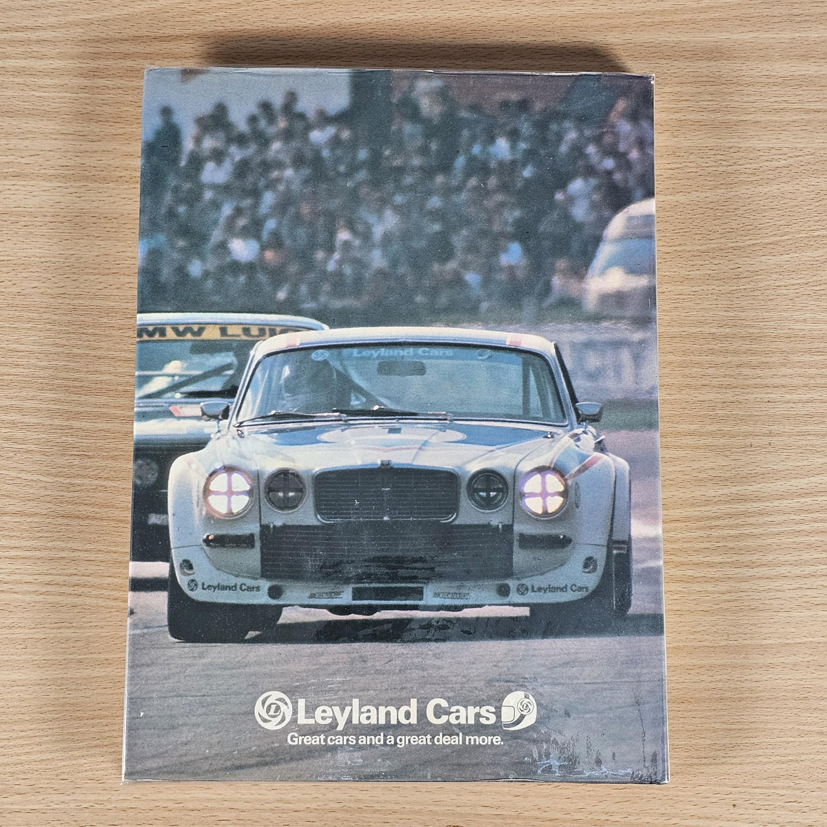 Hardcover racing annual book, photo cover featuring a classic race car and sponsor logo