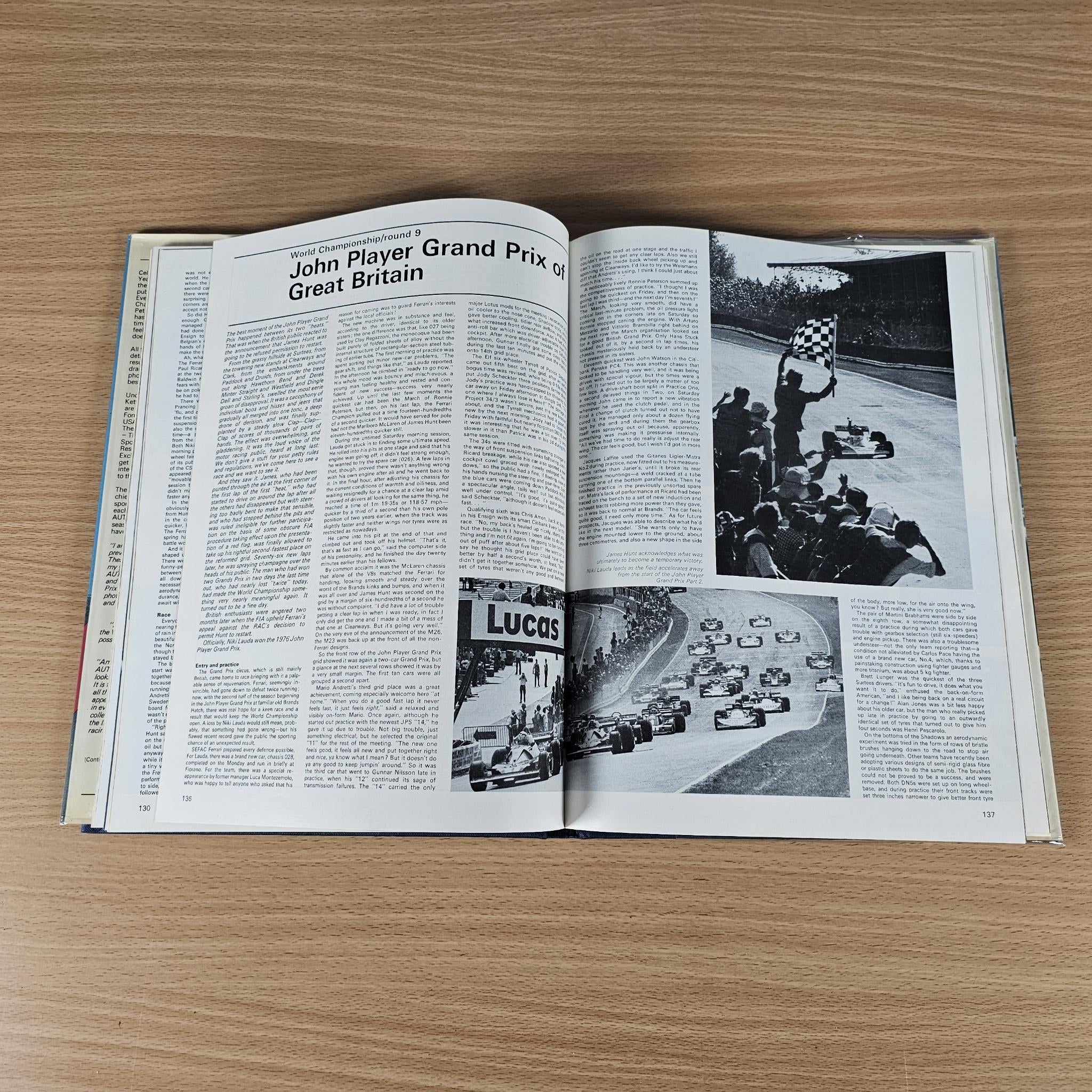 Hardcover motorsport annual, open to pages with photos and race coverage text