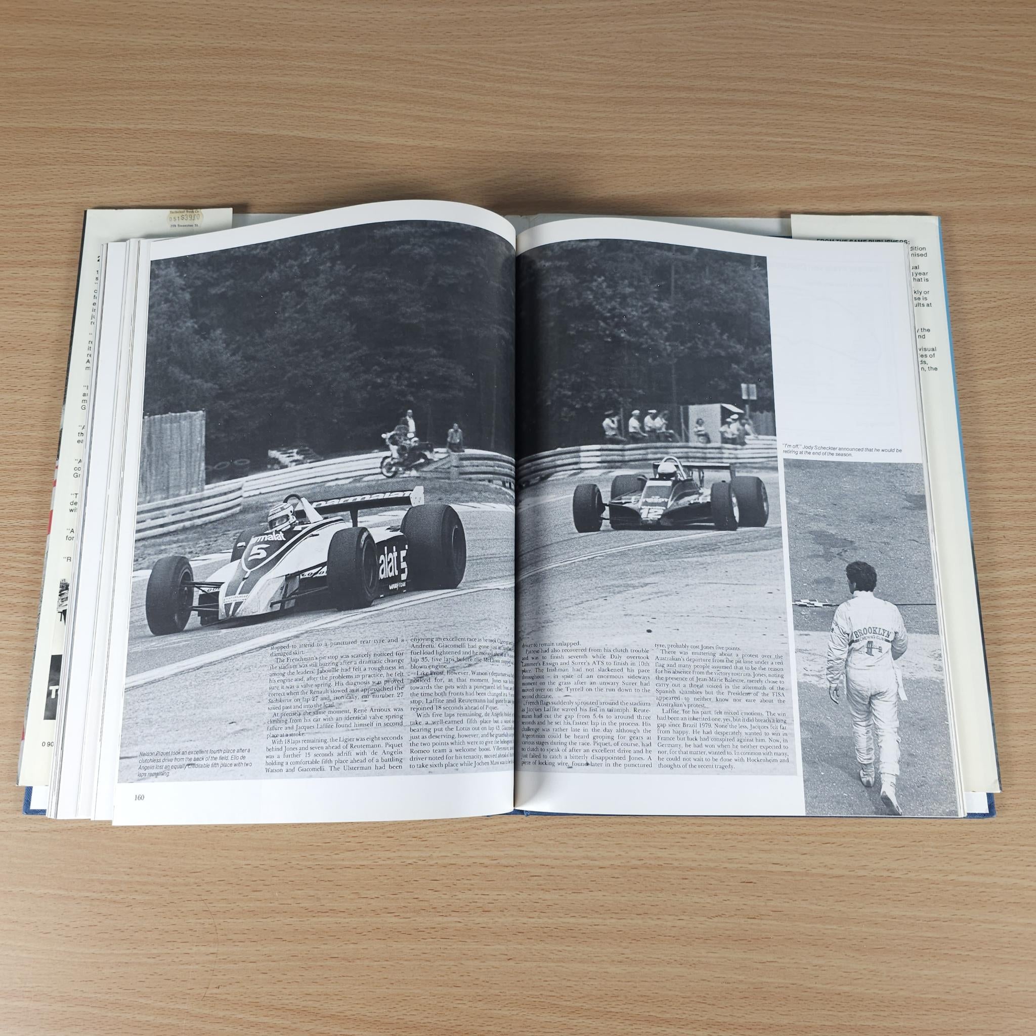 Open racing annual book with black-and-white photo pages