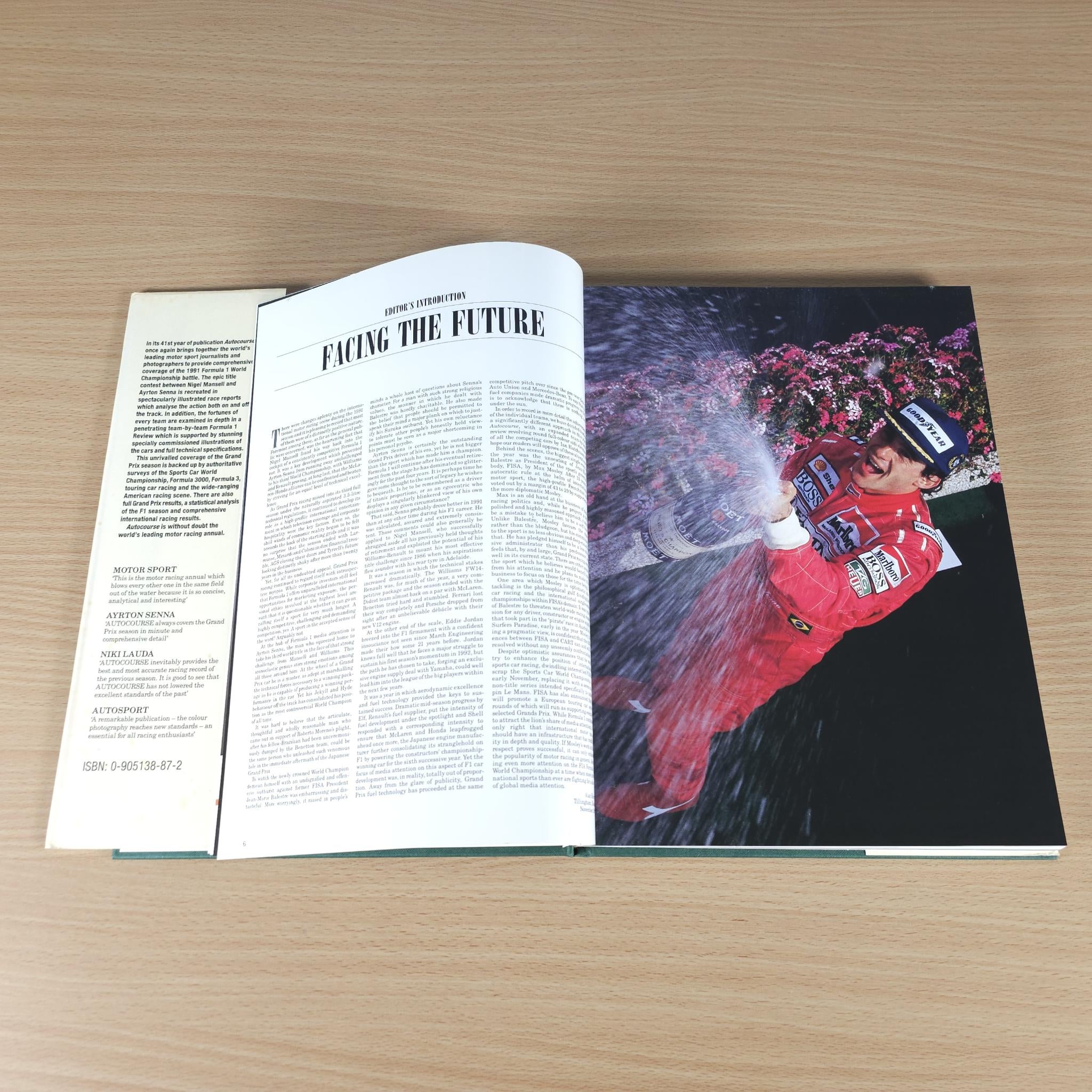 Autocourse 1991-92 book open to feature page with red racing action photo