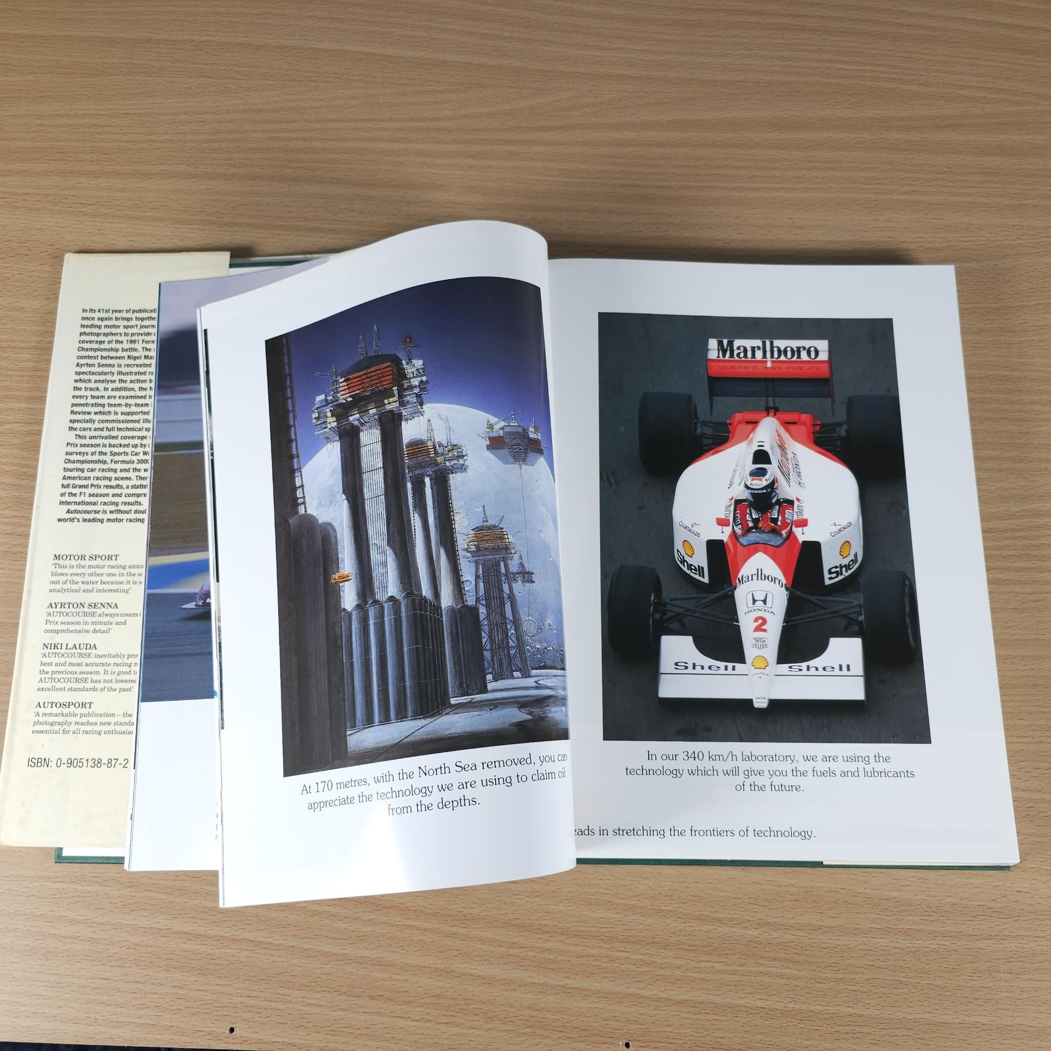 Autocourse 1991-92 book open to pages with race car and city skyline photos