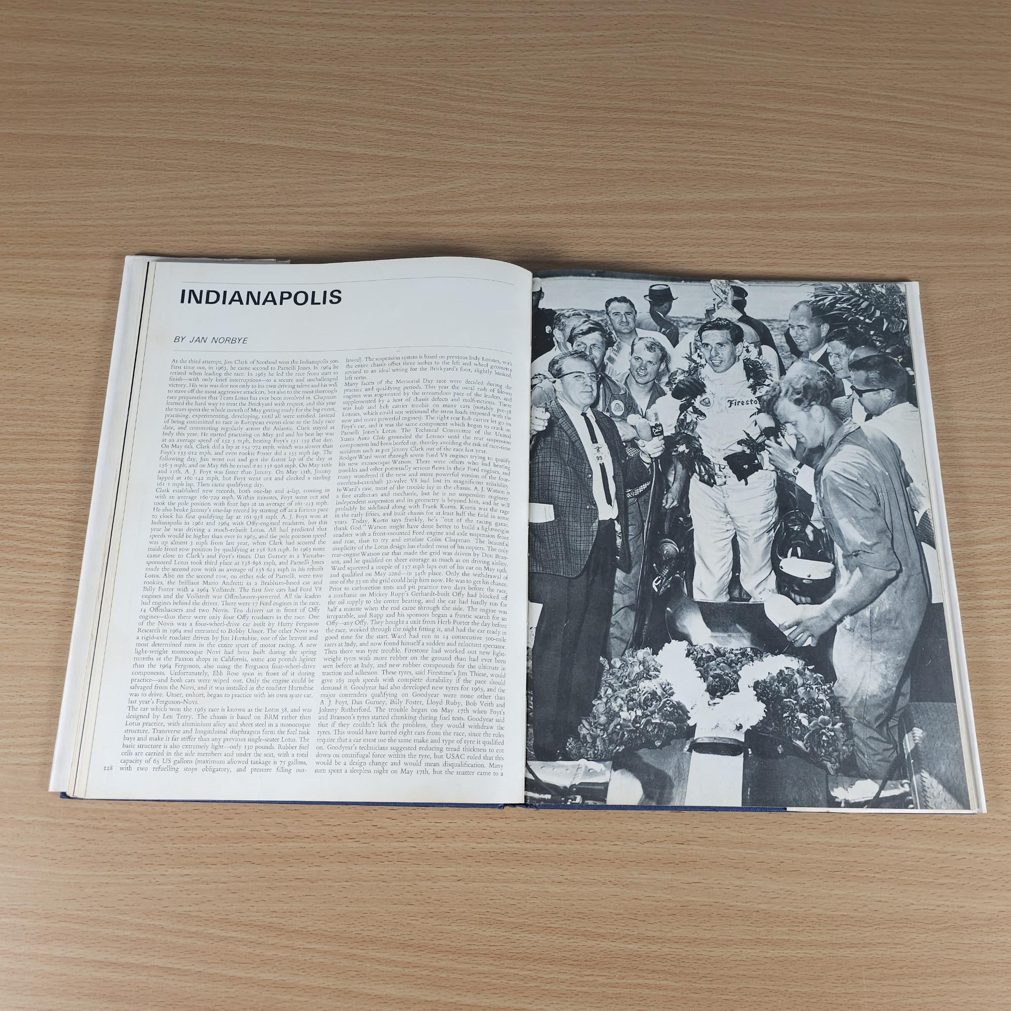 Vintage motorsport review book open to an Indianapolis article with a group photo
