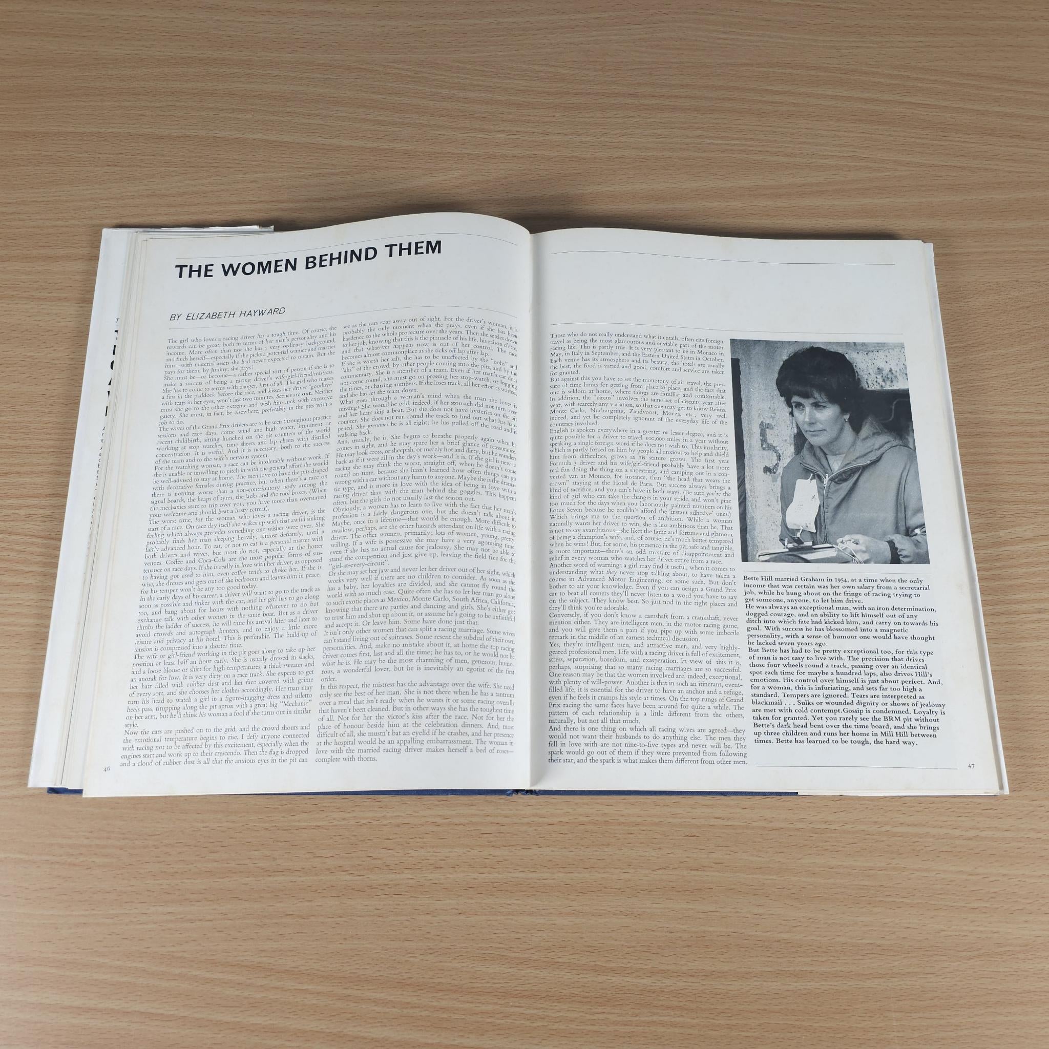 Open vintage motorsport review book spread with portrait photo and dense article text