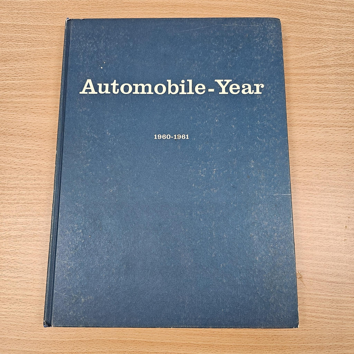 Blue automobile year reference book with front cover text “1960–1961” on top.