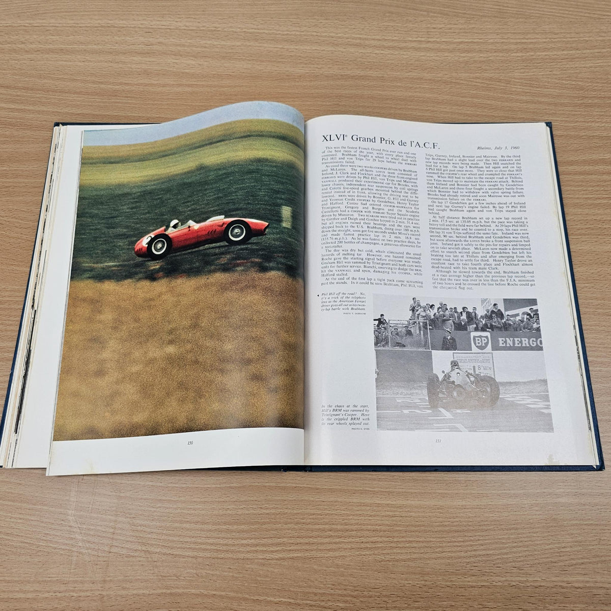 Open vintage automobile book with red sports car illustration and printed text pages