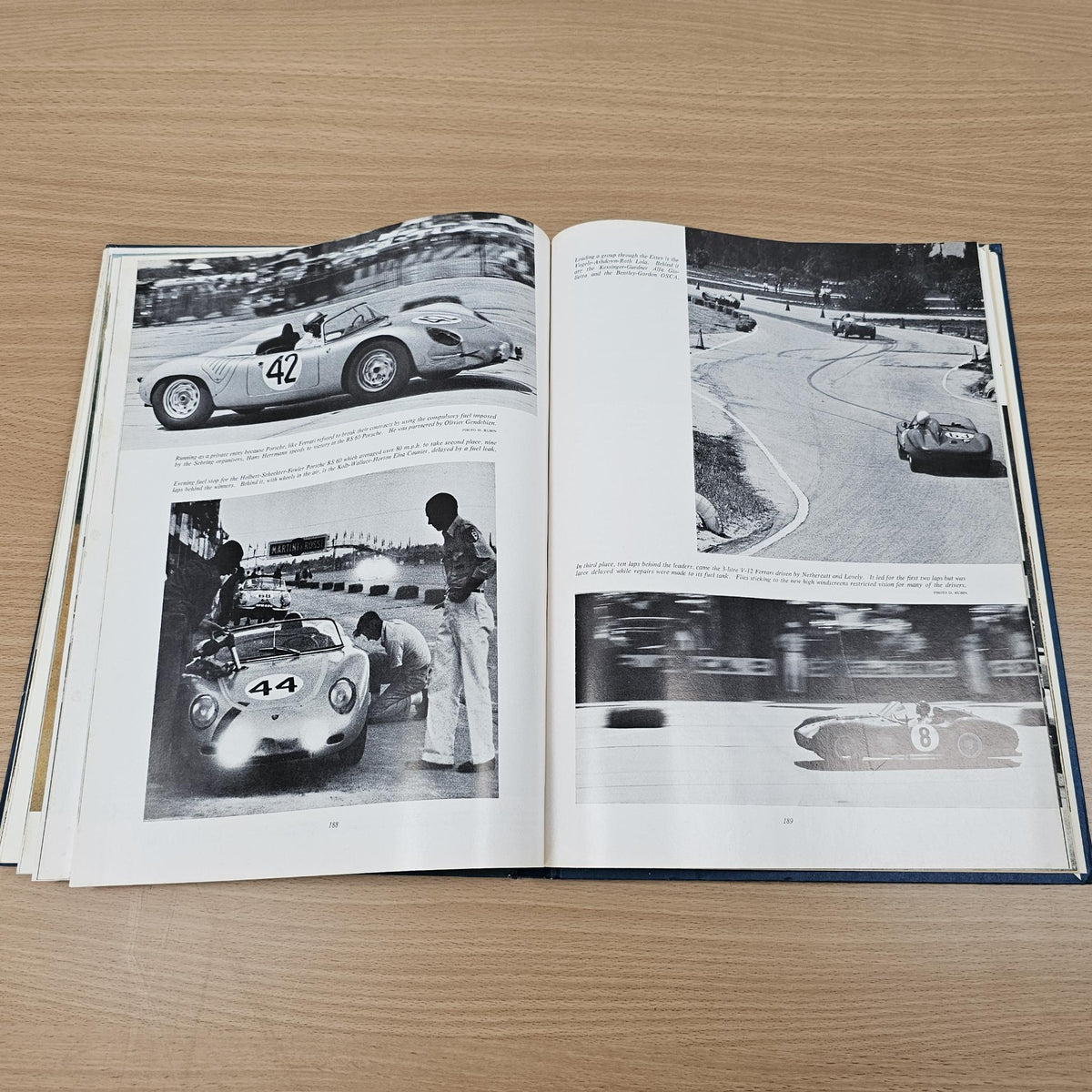 Open vintage automobile book with black-and-white race car and track photo spreads