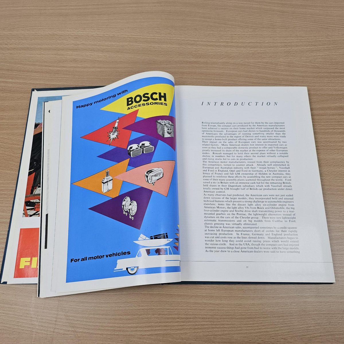 Open automobile year reference book with BOSCH logo page and introduction text columns.