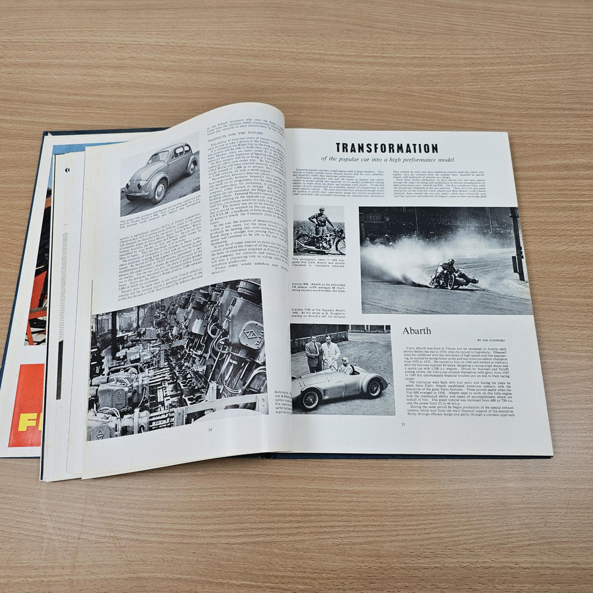 Open automobile year reference book pages with “TRANSFORMATION” heading and vehicle photos.