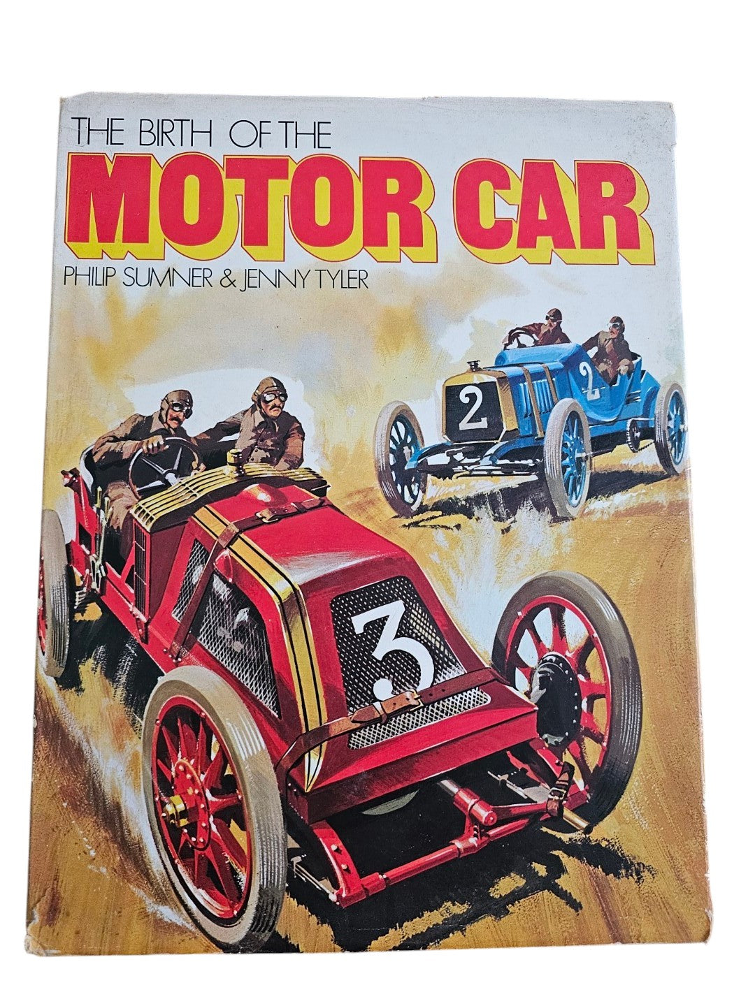 Paperback book cover with title "The Birth of the Motor Car" and red racing car.
