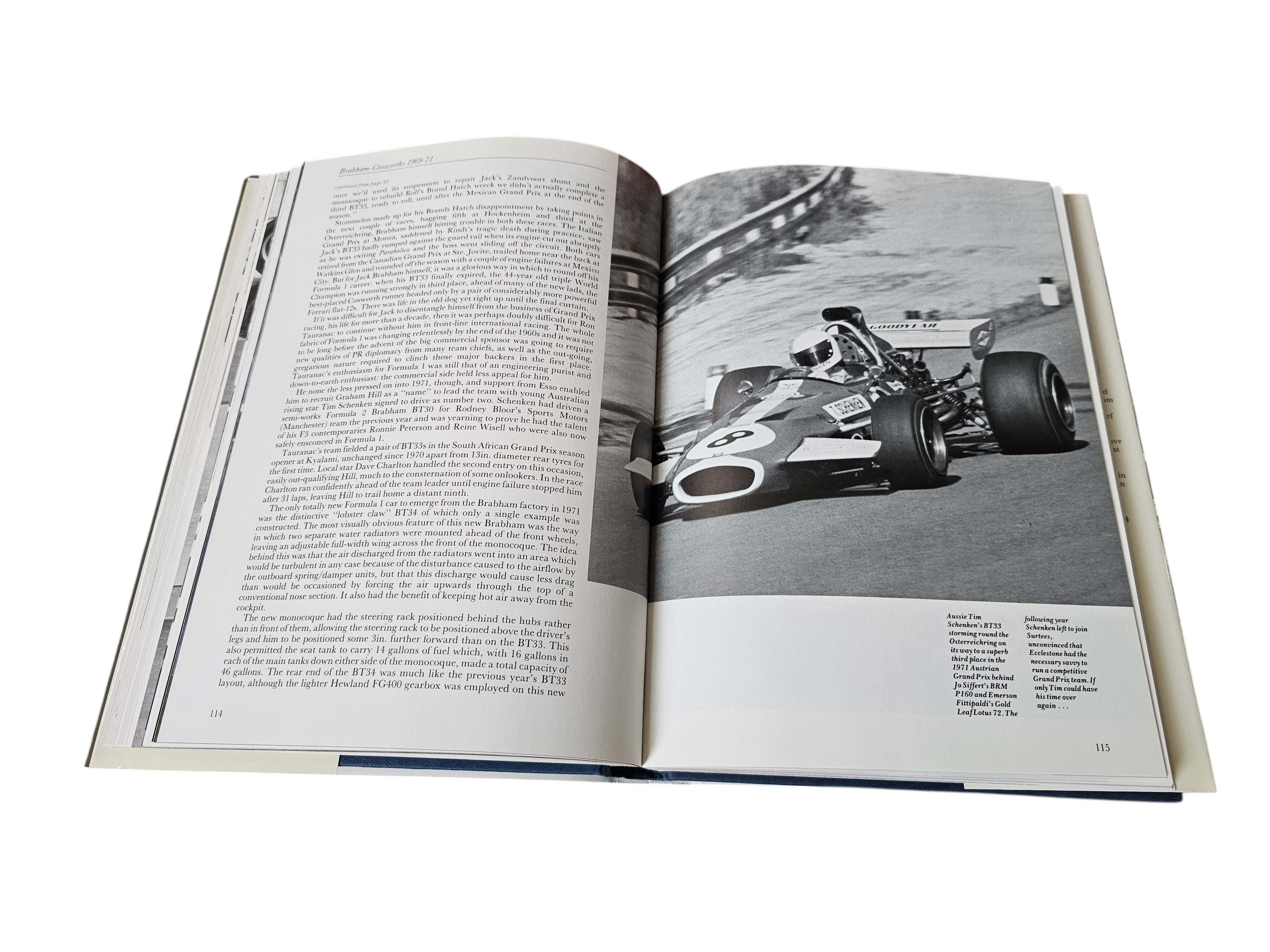 Open hardcover book with racing car photo and printed text on both pages