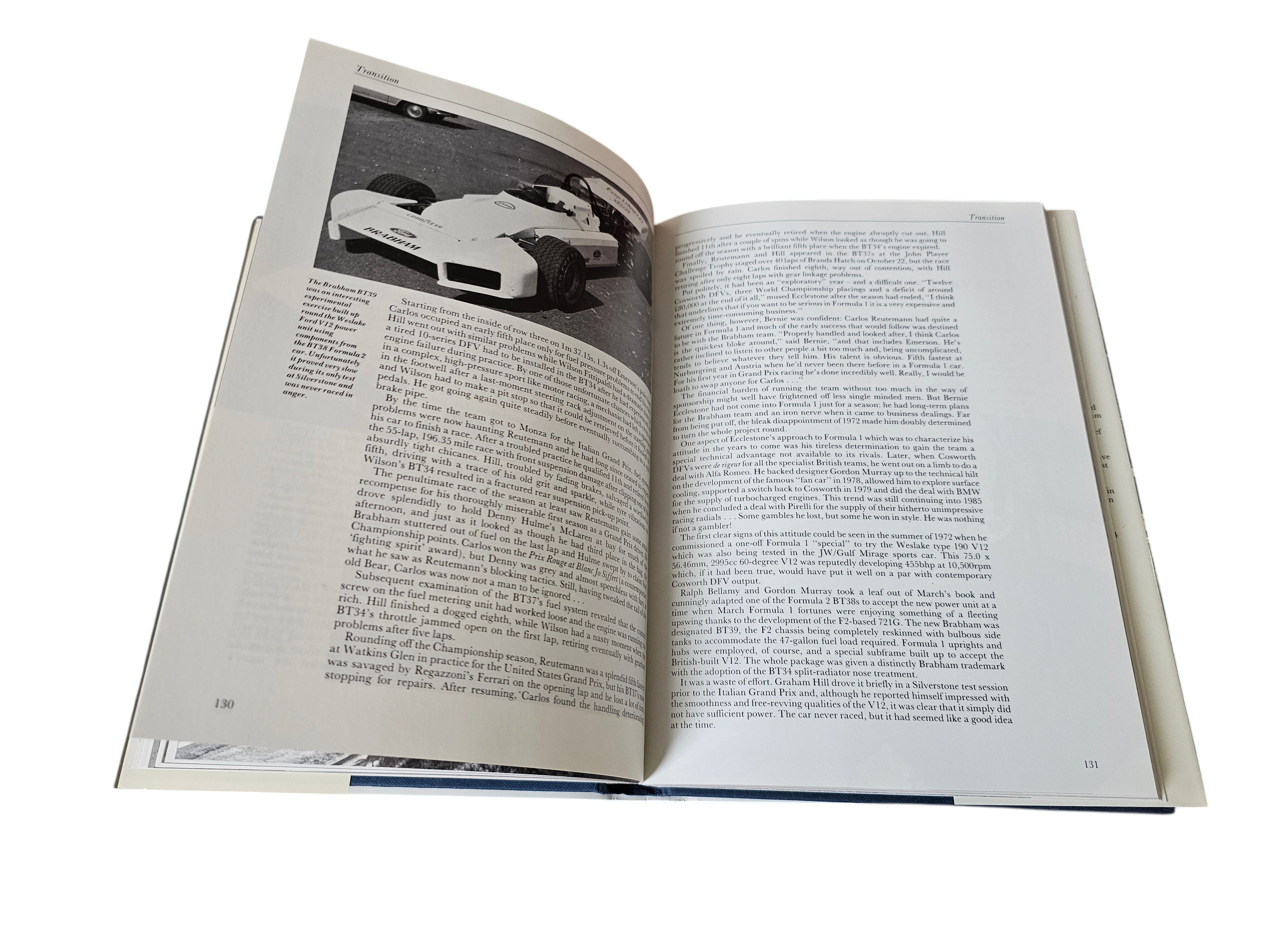 Open hardcover book with monochrome racing photo on left page and text right